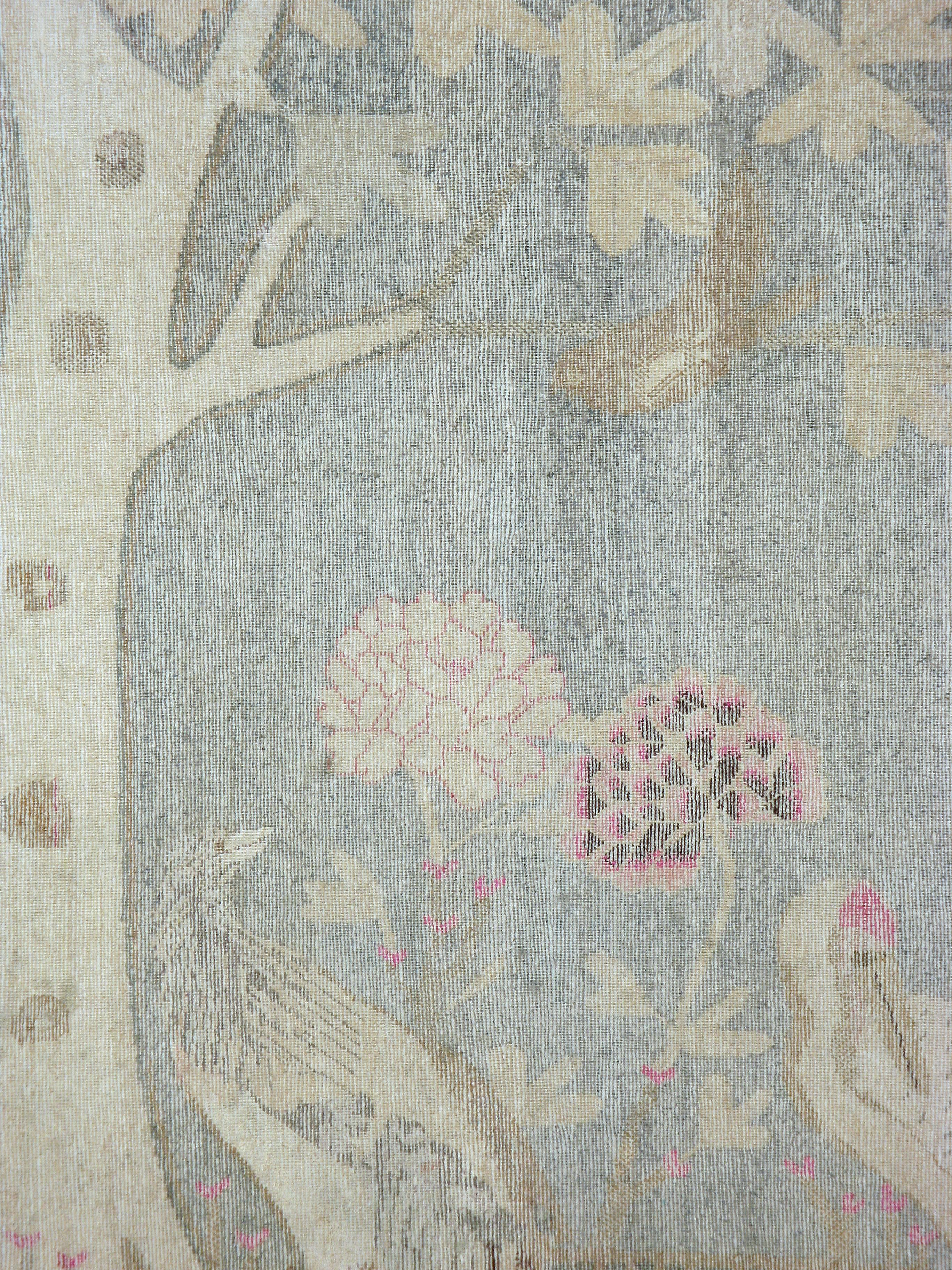 An antique washed East Turkestan Khotan carpet from the first quarter of the 20th century.