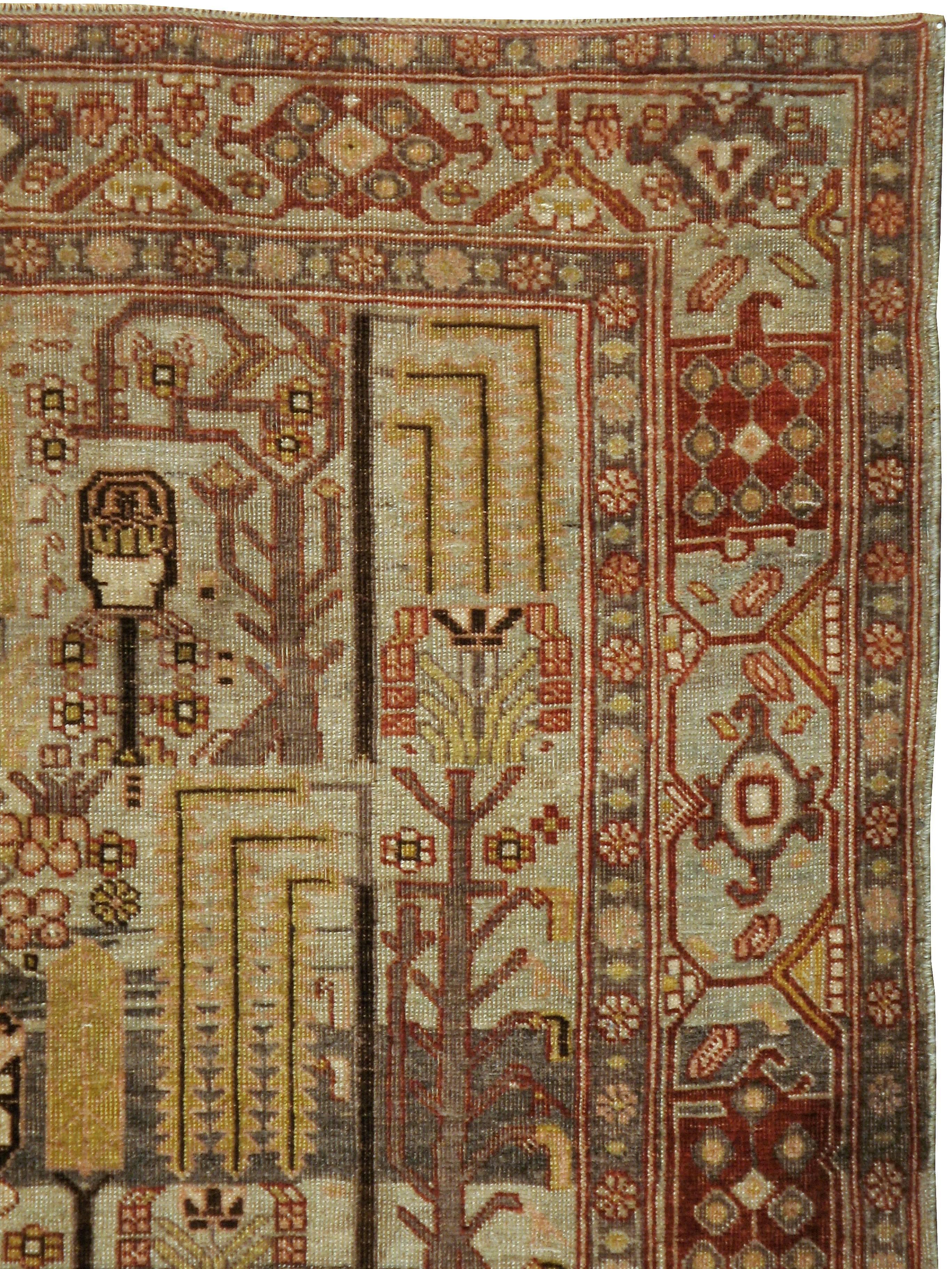 An antique washed Persian Bidjar carpet from the first quarter of the 20th century.