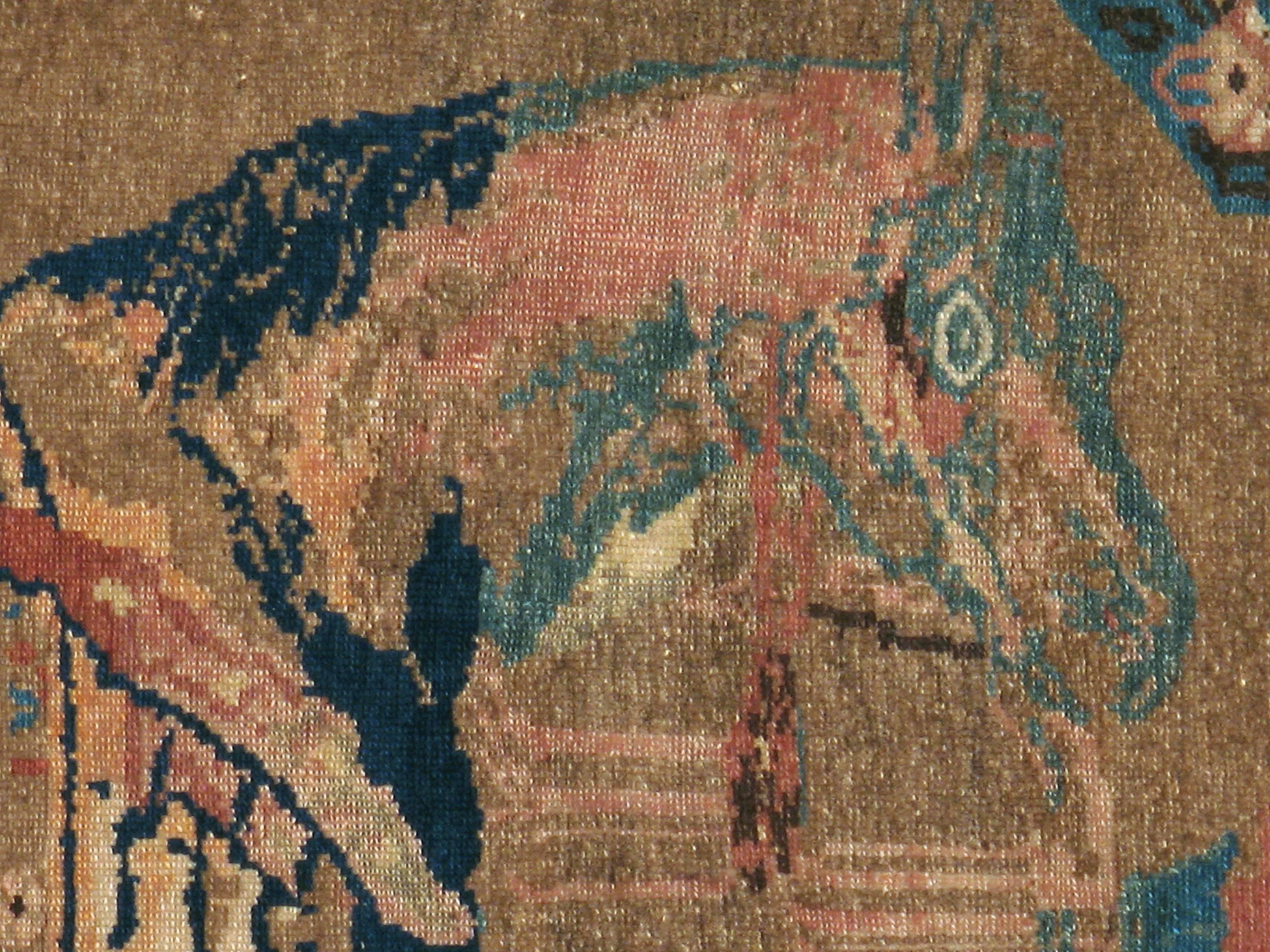 An antique Persian Malayer carpet from the turn of the 20th century with a pictorial design of a horse.