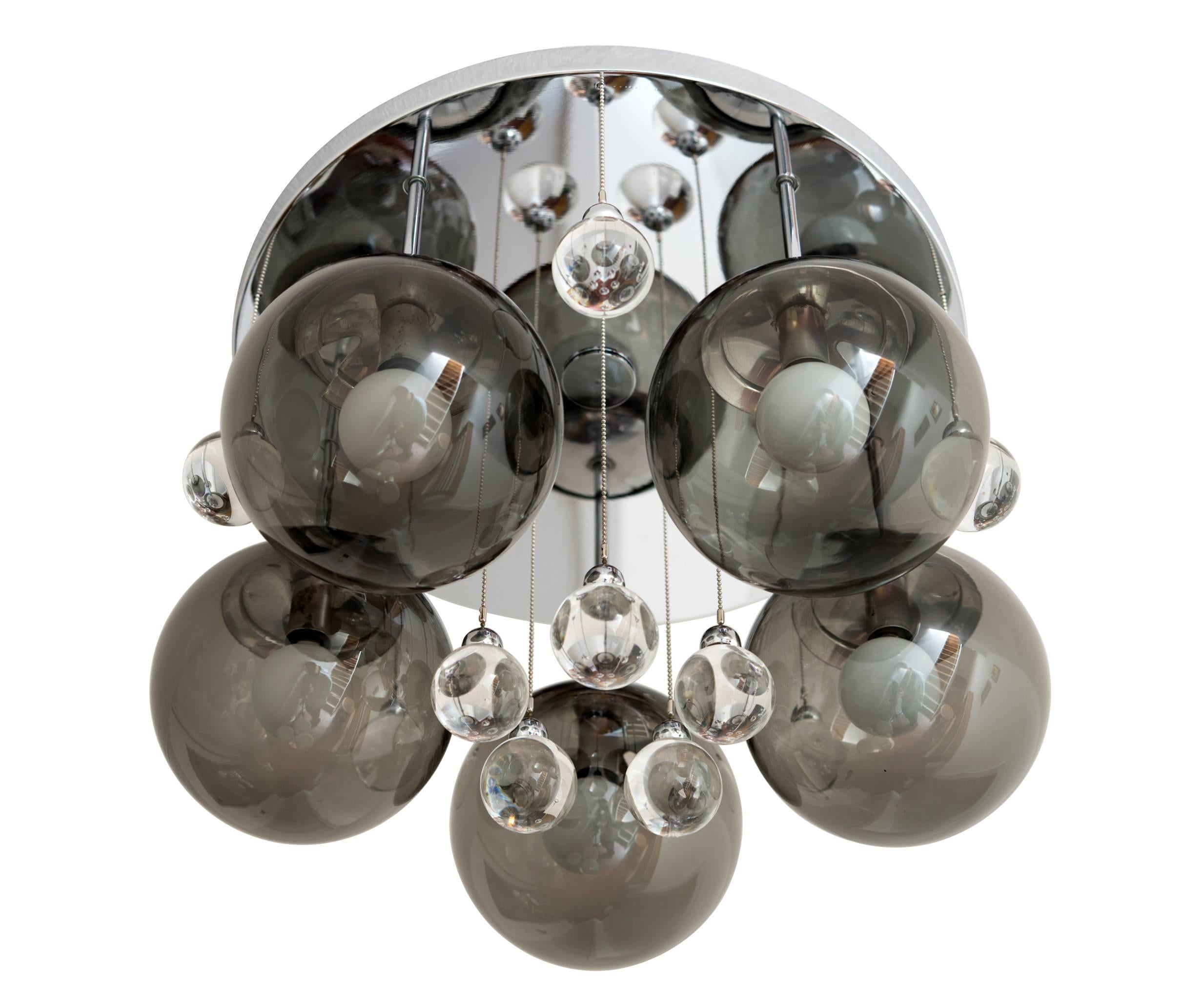 A striking pair available of 1960s flush mount light fixtures or chandeliers with polished chrome frames, each supporting five pendant lights with smoked, blown glass shades and ten solid glass 'bubbles' with chrome mounts and suspended by ball
