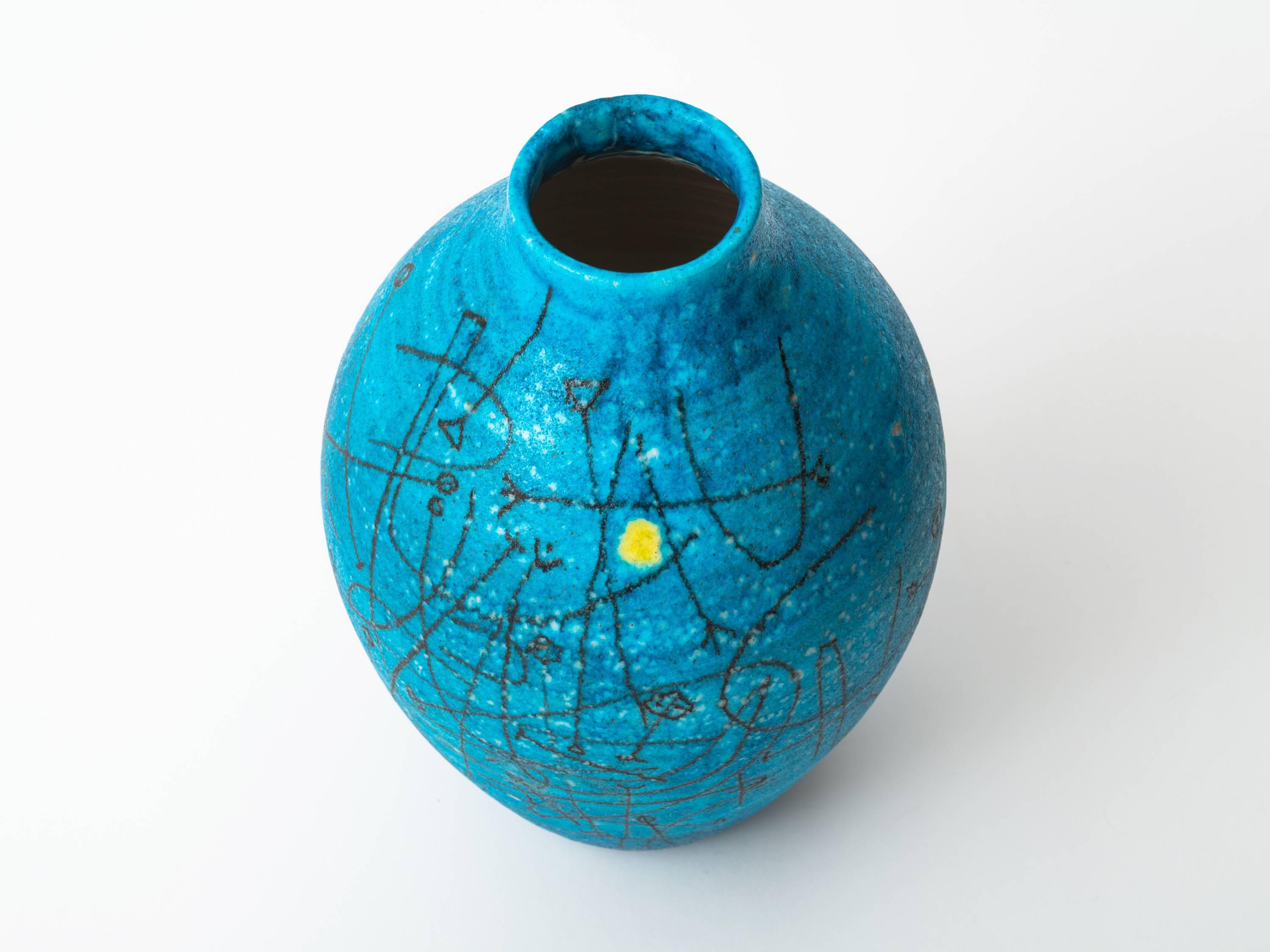 A vibrant, hand-thrown pottery vase or urn by Guido Gambone, circa 1955, in a deeply saturated shade of Mediterranean blue. Wonderful contrast between the more traditional form and the modernist design motif whose lone, yellow dot on a field of