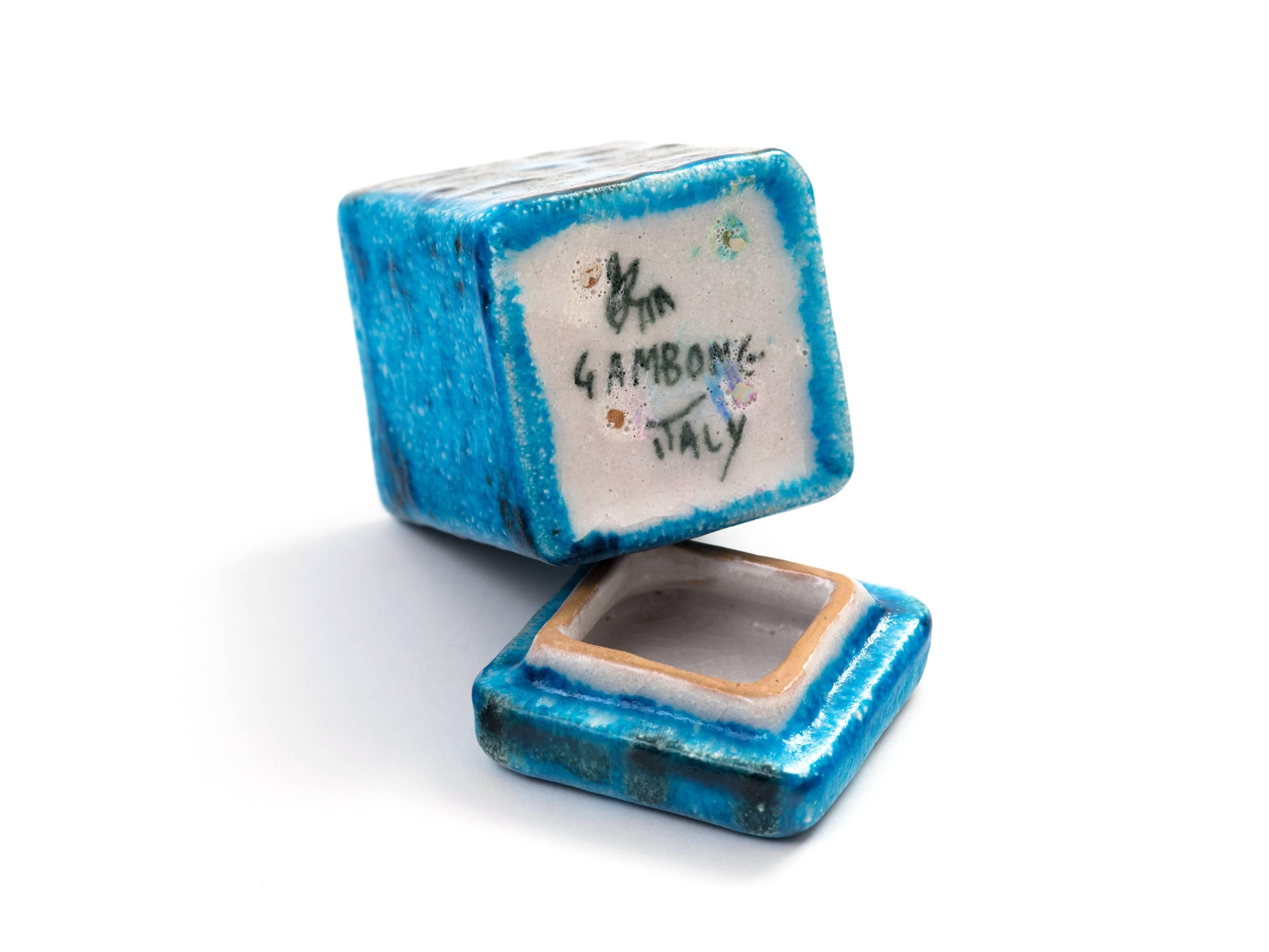 *Priced individually*

Two decorative, lidded ceramic boxes by Guido Gambone, 1950s:

Square, Mediterranean blue box with black, hieroglyphic or tribal design, finished in a smooth glaze. Measures 4.25 H x 2.75 W x 2.75 D.

Rectangular,