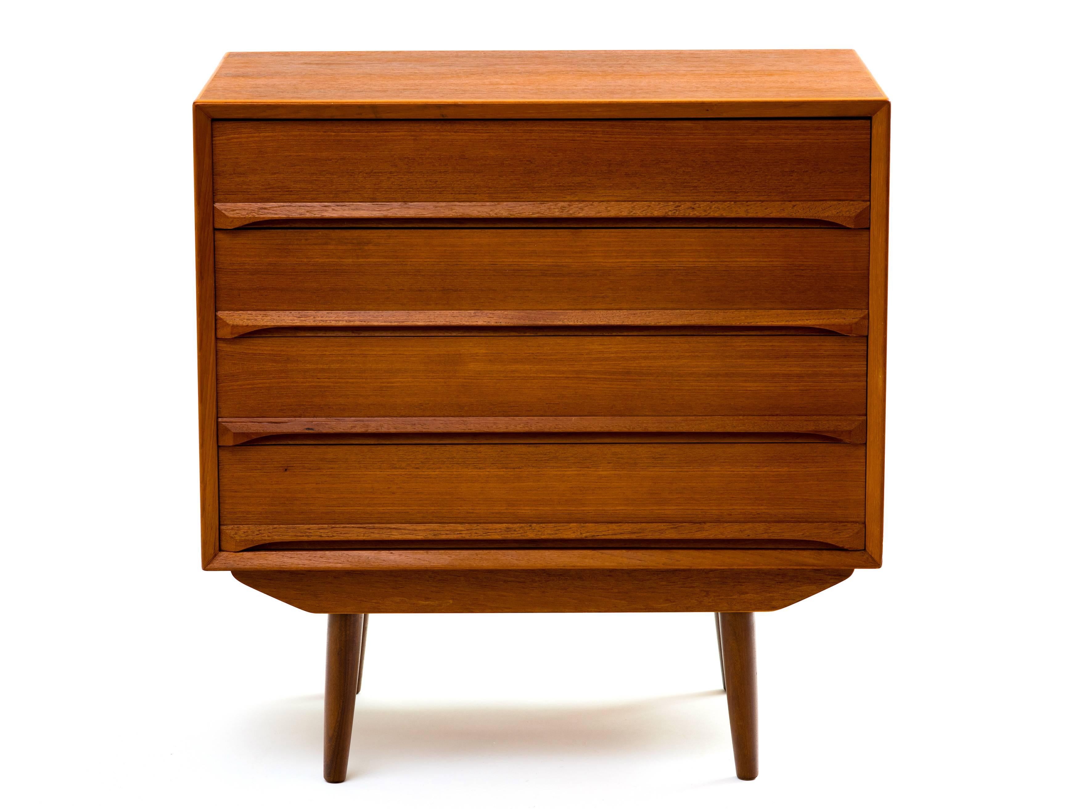 A petite chest of drawers or dresser in teak designed by Svend Aage Madsen for Falster, 1960s. A perfect choice for a small space with attractive features: chamfered front edges, 'skirt' detail between the body and legs at both front and back,
