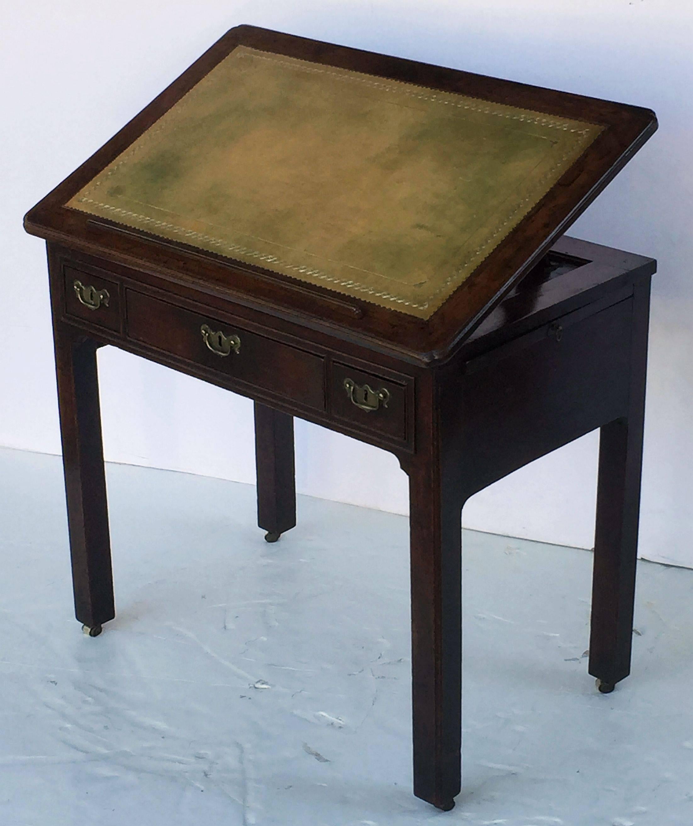 A handsome English architect's or library table (or draughting desk) from the Georgian Era, circa 1760, featuring a moulded mahogany slope top with embossed leather writing or drawing surface, with adjustable height stand and brass locking hardware