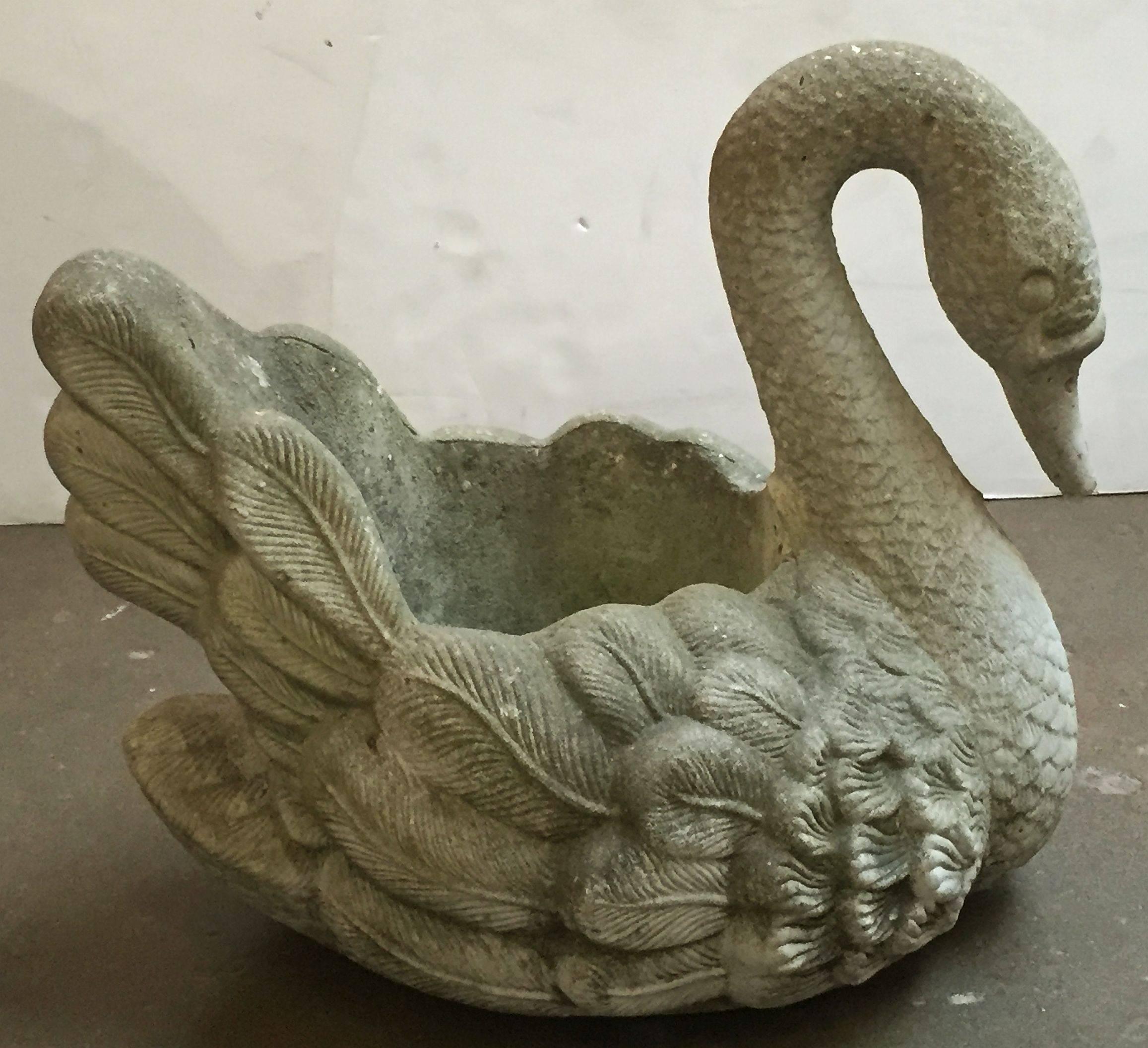 A large English garden planter of composition stone in the form of a swan, featuring graceful lines and fine detail.