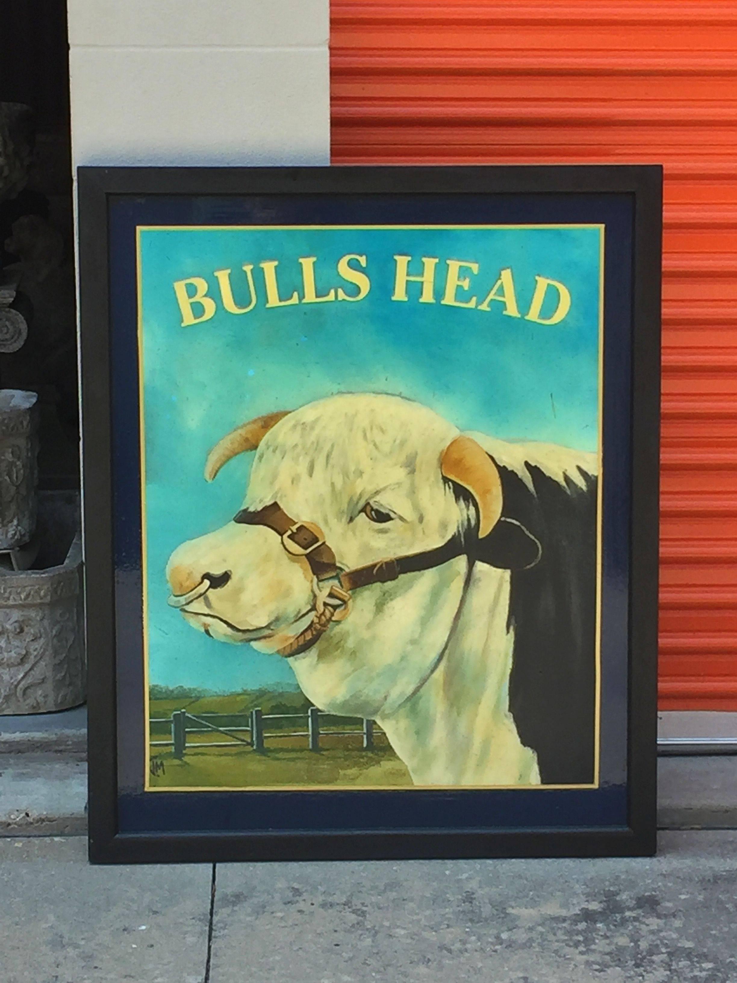 An authentic English pub sign (one-sided) featuring a painting of a bull's head, against a fence line and pasture in the background, entitled: Bulls Head. 

A very fine example of vintage advertising artwork, ready for display.