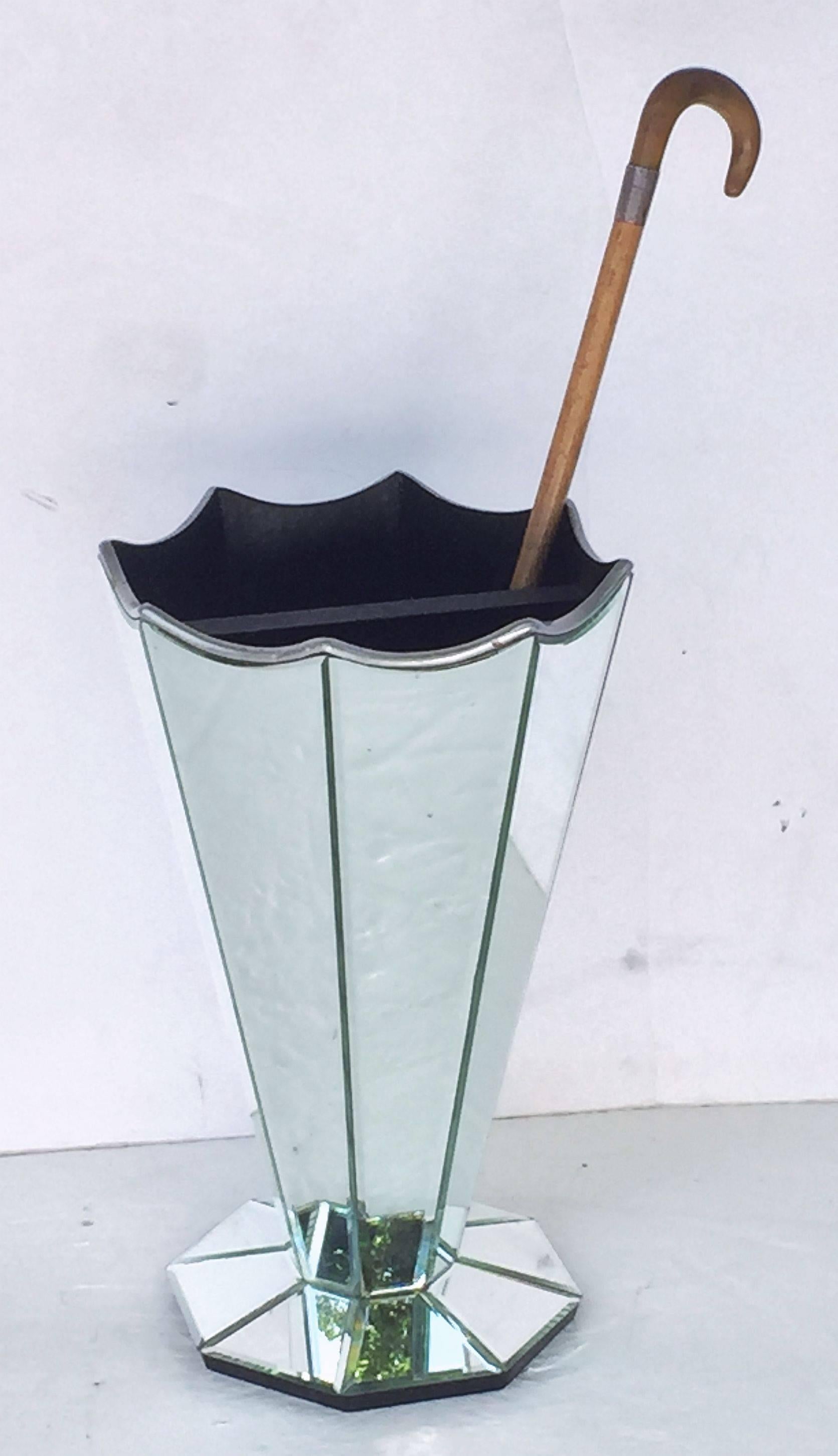 A fine English umbrella or stick stand, featuring an Art Deco or modernist design, with eight faceted sides of mirrored glass mounted to a wooden base, with silver and black accents.