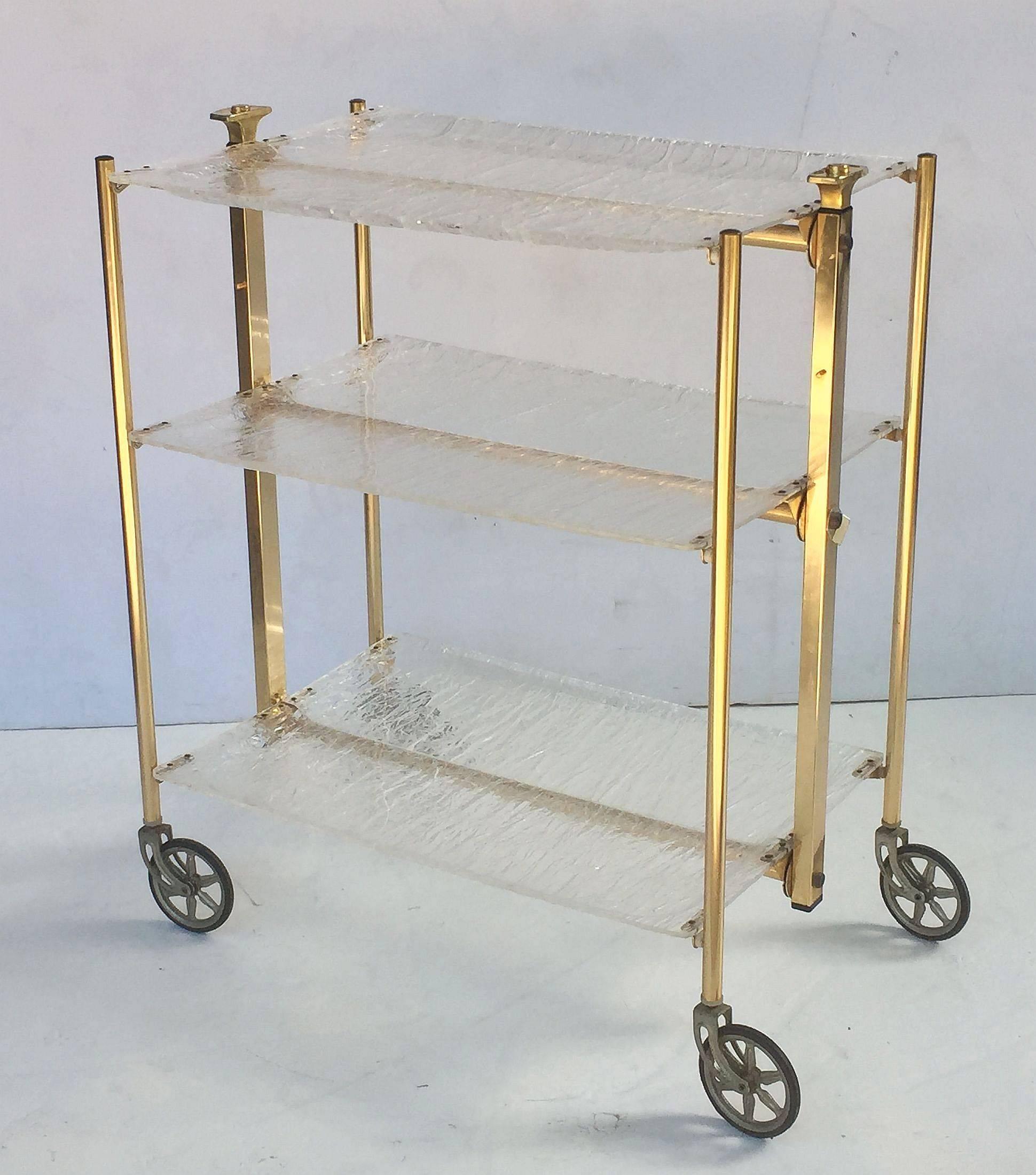 A handsome French bar cart table or drinks trolley, featuring three tiers of textured acrylic, mounted to four legs with rolling casters.
The cart is lightweight and collapsible for storage by pressing a button.

Makes a great side or occasional