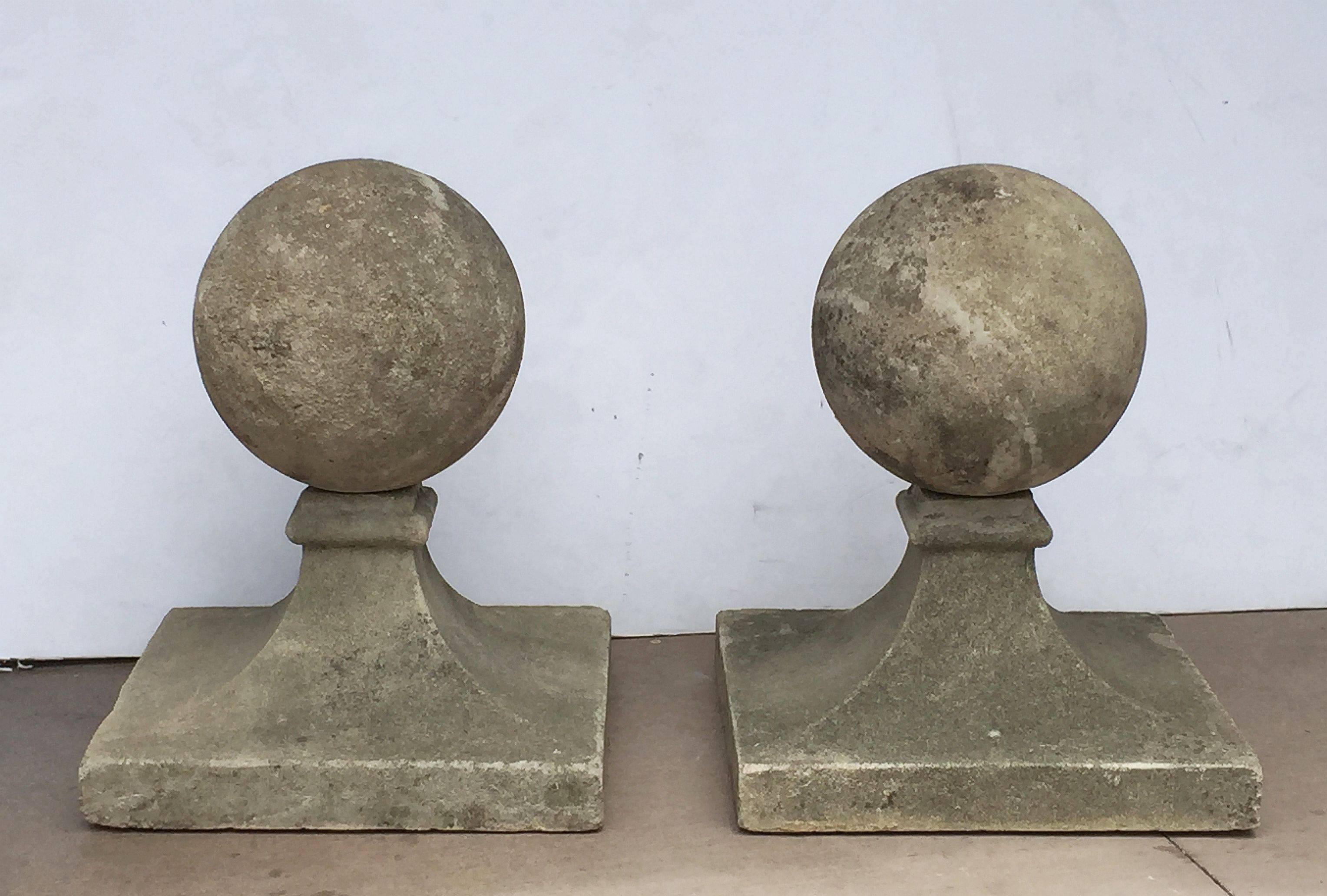 A fine pair of large English coping balls of composition stone, each ball set upon a square plinth base.

Dimensions are H 23
