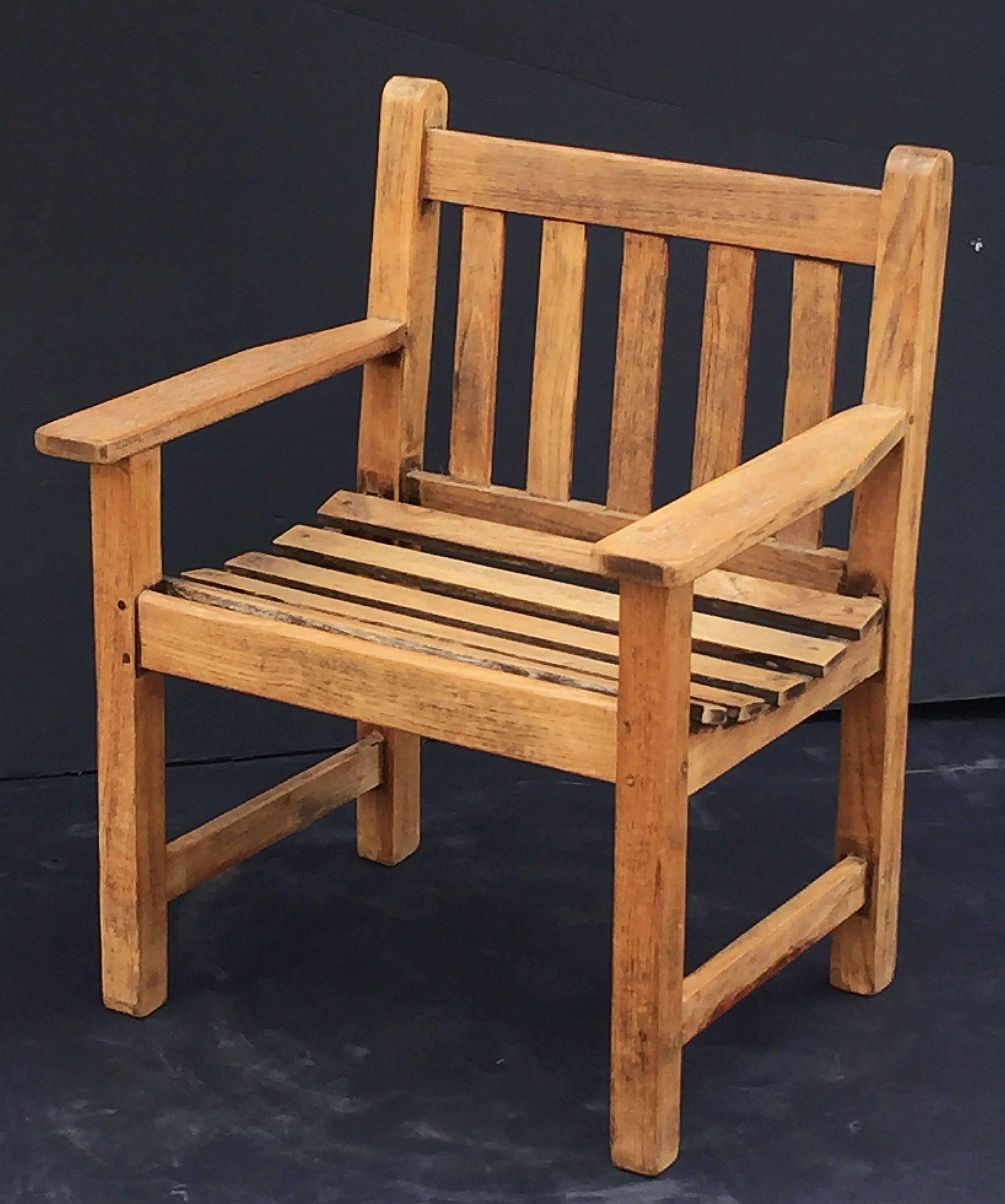 A comfortable English garden or patio chair of fine, aged teak wood, featuring a slat back and seat and a stylish frame.

By the early 1900s, R.A. Lister developed a successful line of wood-based garden furniture.

This chair has a tab that