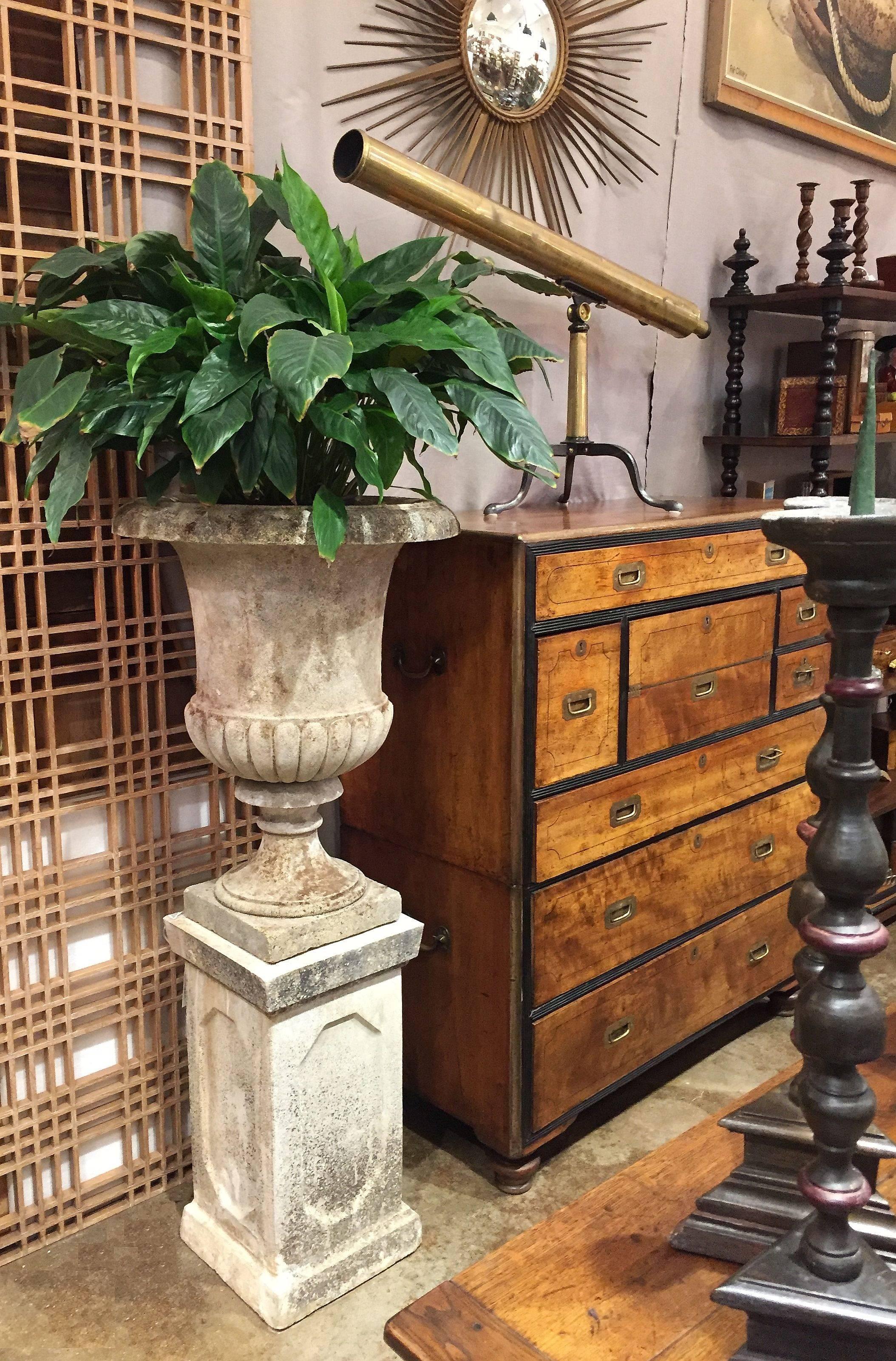 A fine English garden urn on plinth of composition stone in the Classical style, featuring a tall urn with semi-lobed body on raised square base, set upon a square plinth with decoratively recessed sides.

Perfect for a garden room or conservatory!