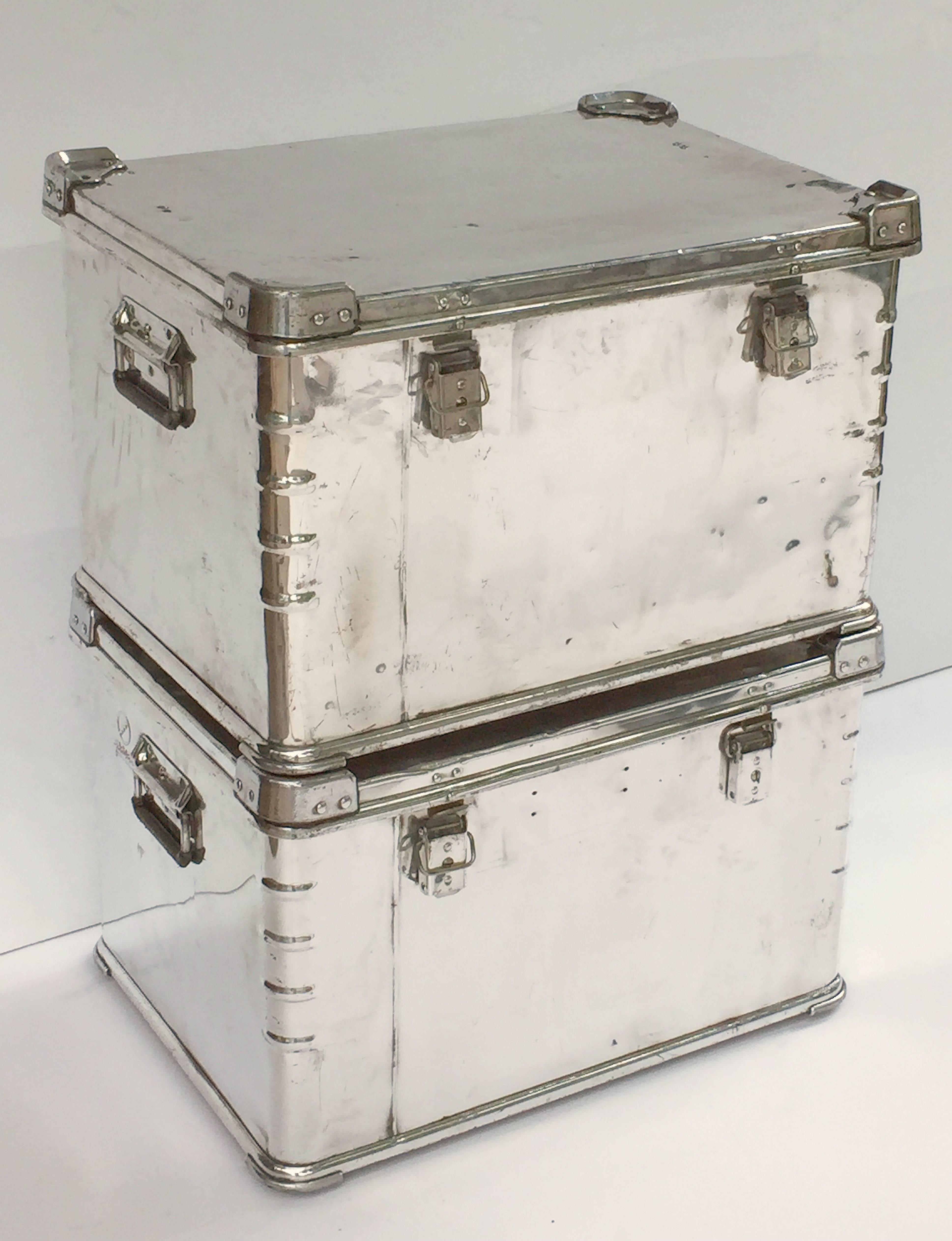 A fine pair of German luggage or storage trunks of polished aluminum each rectangular trunk featuring a fitted, hinged top with reinforced corners. Each trunk with plastic shielded handles.

Individually priced - $3495 each trunk.