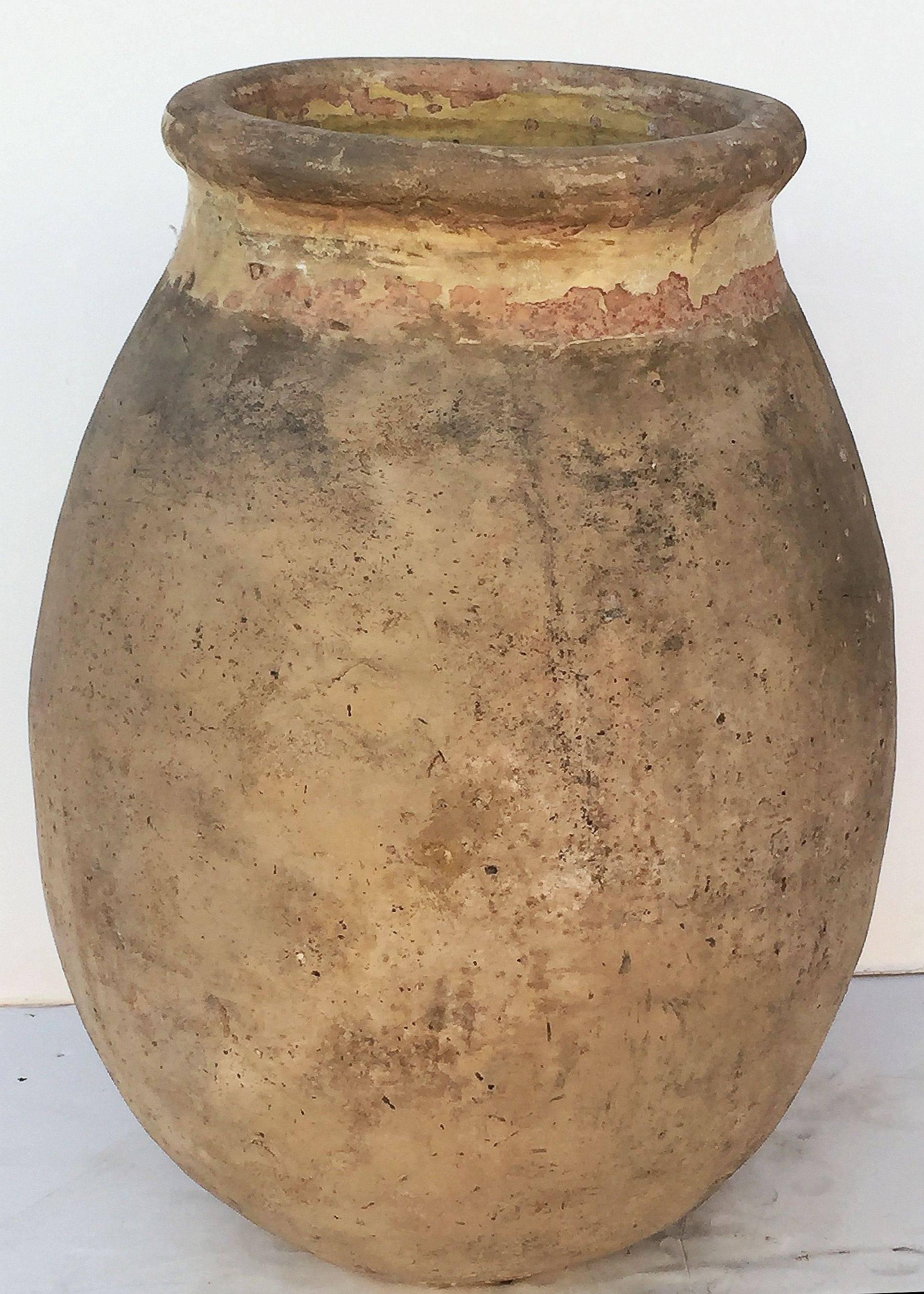 A handsome French garden pot or oil jar from the Biot, Alpes-Maritimes, region known as a pottery centre from the 18th century onward.

Featuring a glazed rolled-edge top over a smooth, cylindrical body and functional as a garden ornament, fountain,