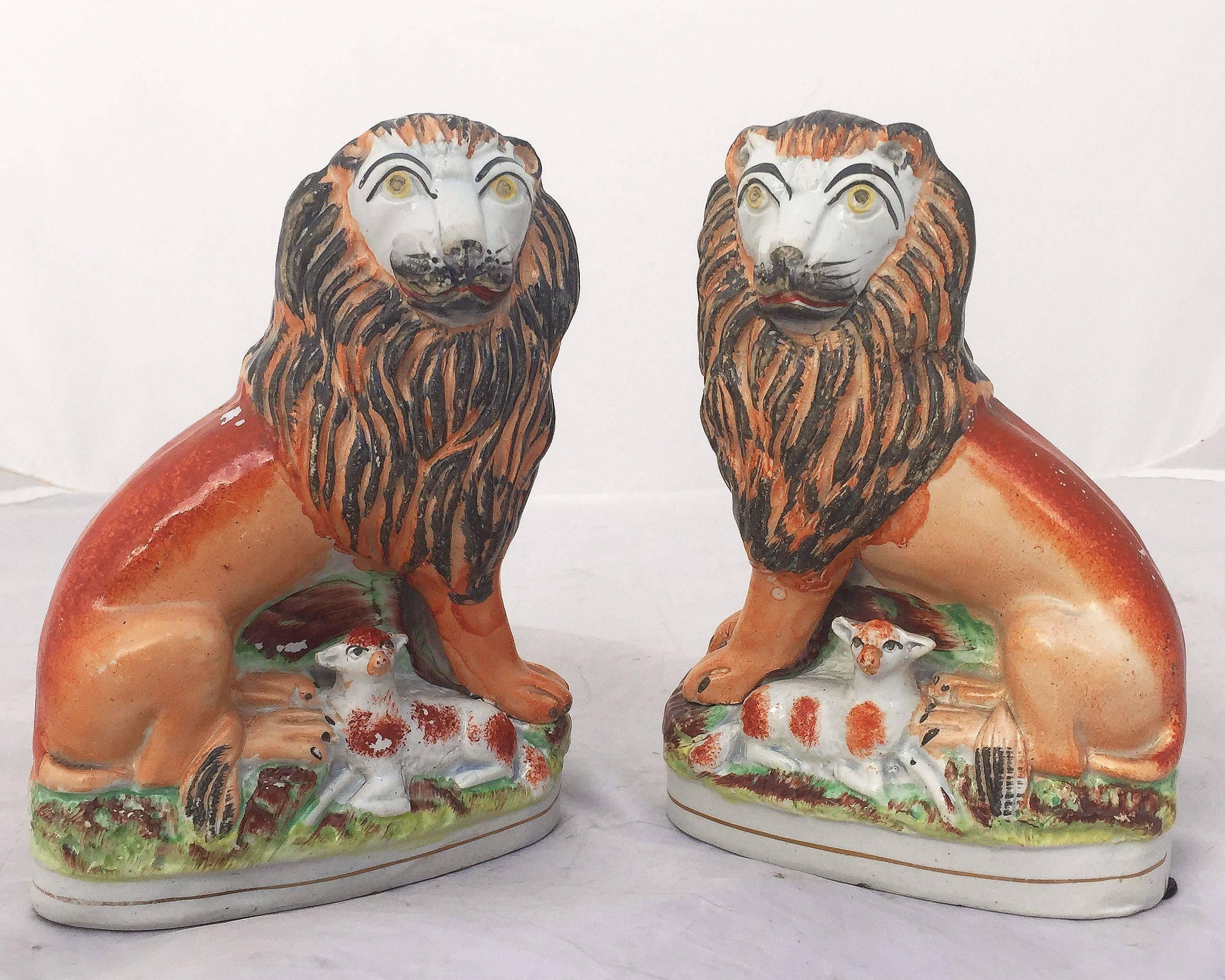 A handsome pair of English Staffordshire pottery decorative animal sculptures, finely modeled and colored as lions with recumbent lambs.
Decorated 'in the round' - decoration to front and reverse.

Denoted as rare among collectors, the pair