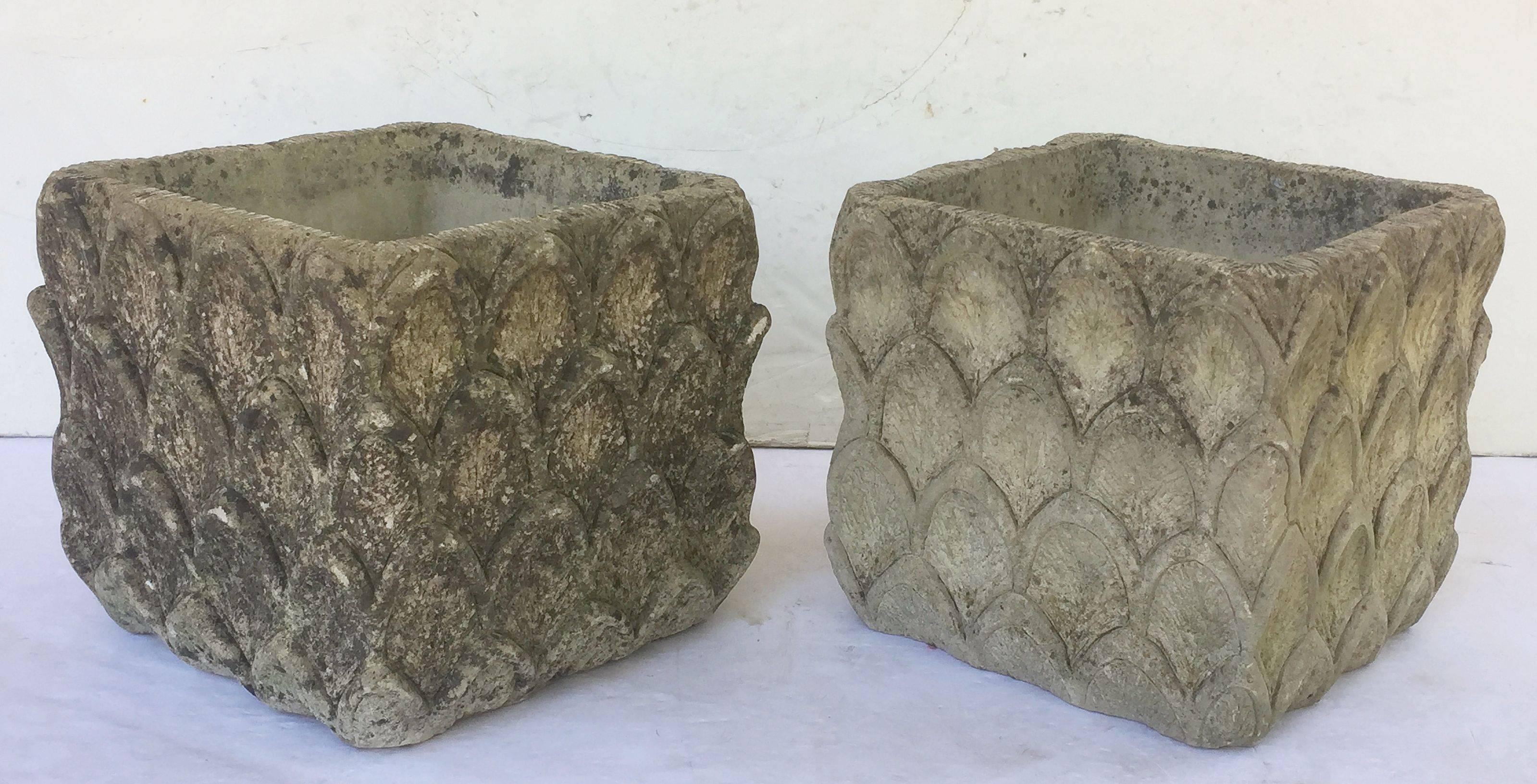 A pair of fine English garden planters or pots of composition stone from the Cotswolds, each square or box pot featuring a raised relief design around the circumference.

Perfect for a garden room or conservatory.

Two available - Priced