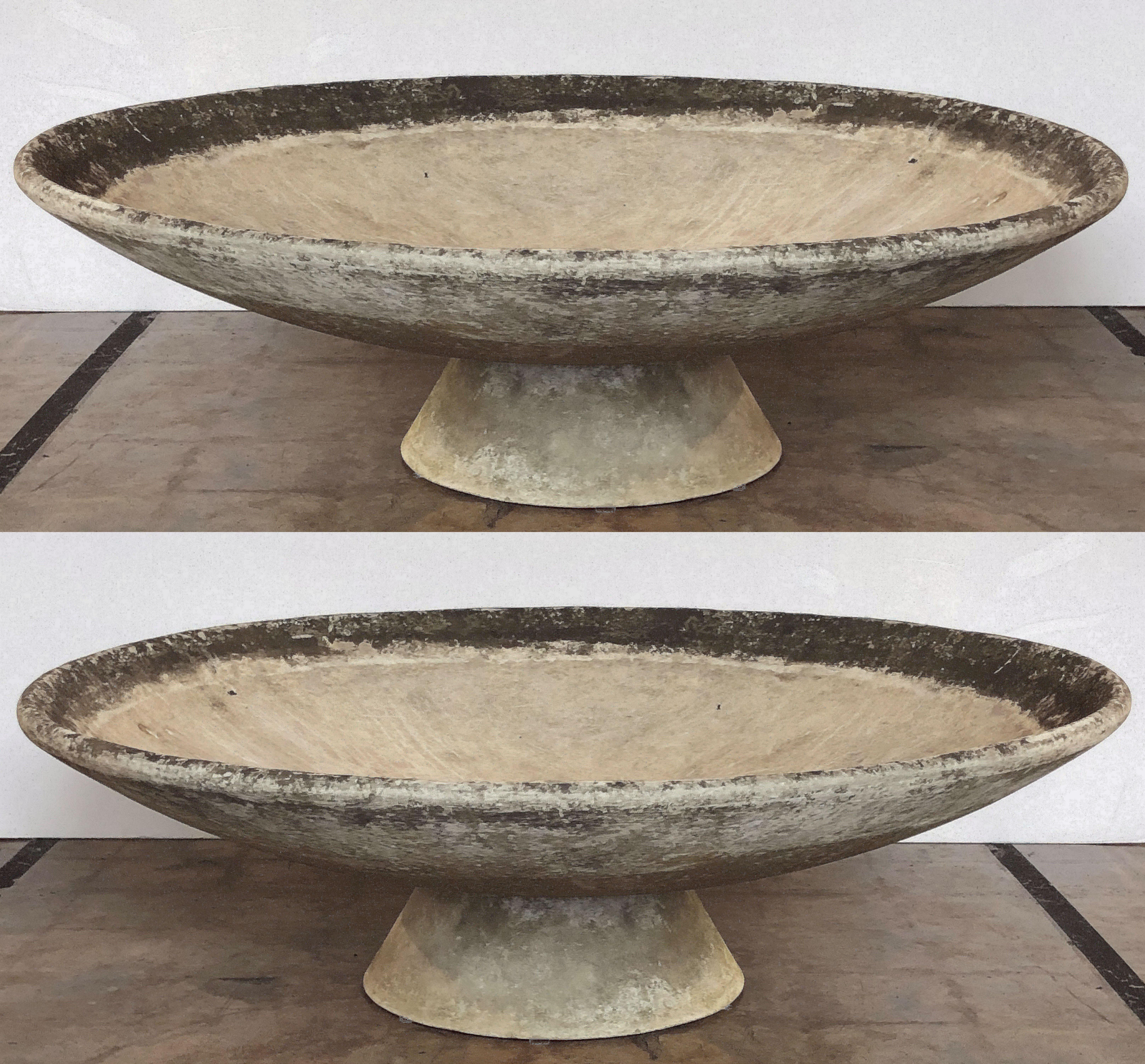 A fine pair of very large Mid-Century Modern large saucer planters of composition stone for an indoor or outdoor garden, garden room, or terrace, designed by the iconic Swiss designer, Willy Guhl. Each large round or circular discus resting on a