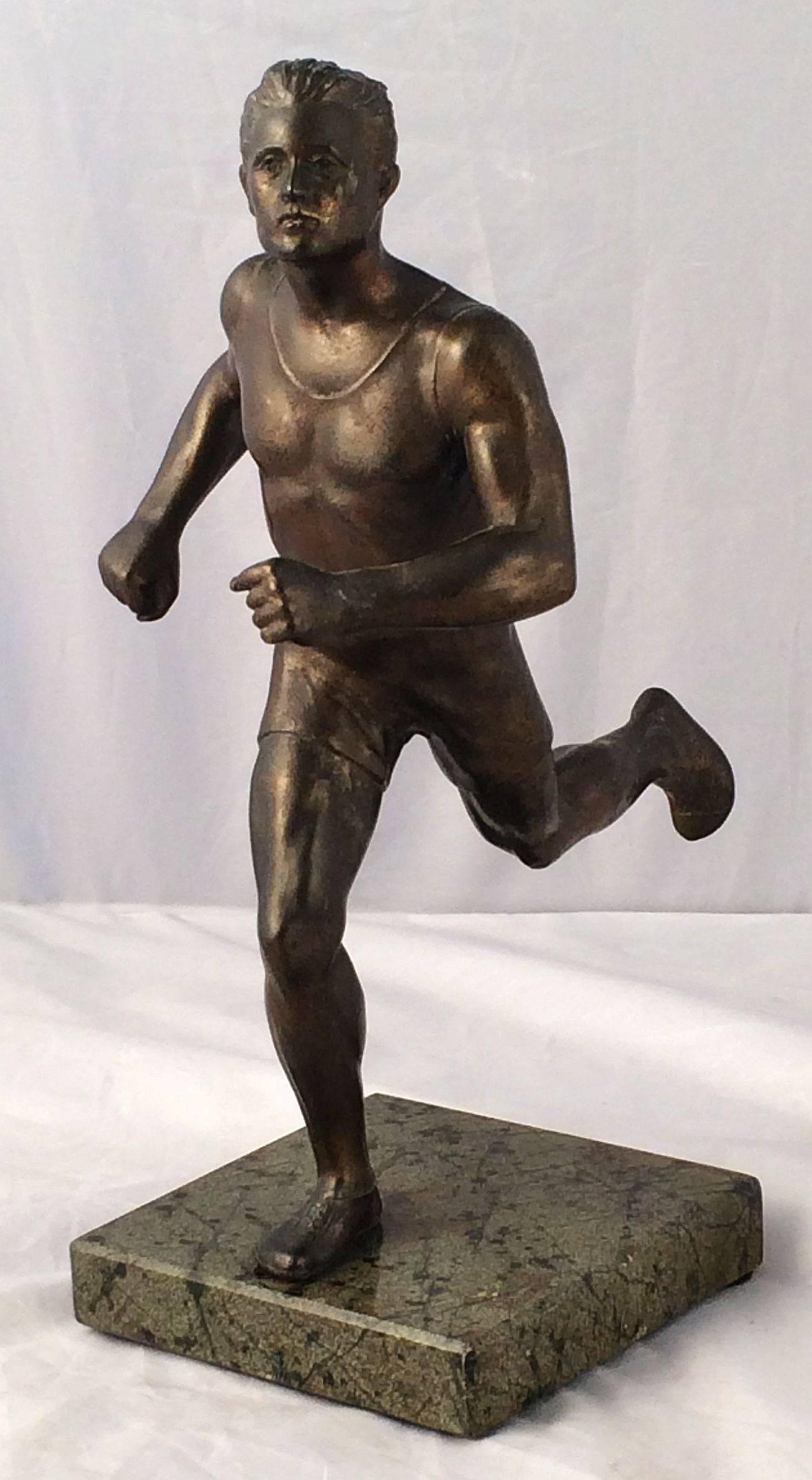 A fine German sports trophy featuring a sculptural figure of a marathon runner or sprinter mounted to a square marble base.

Makes a great gift for a decathlon or jogging enthusiast.