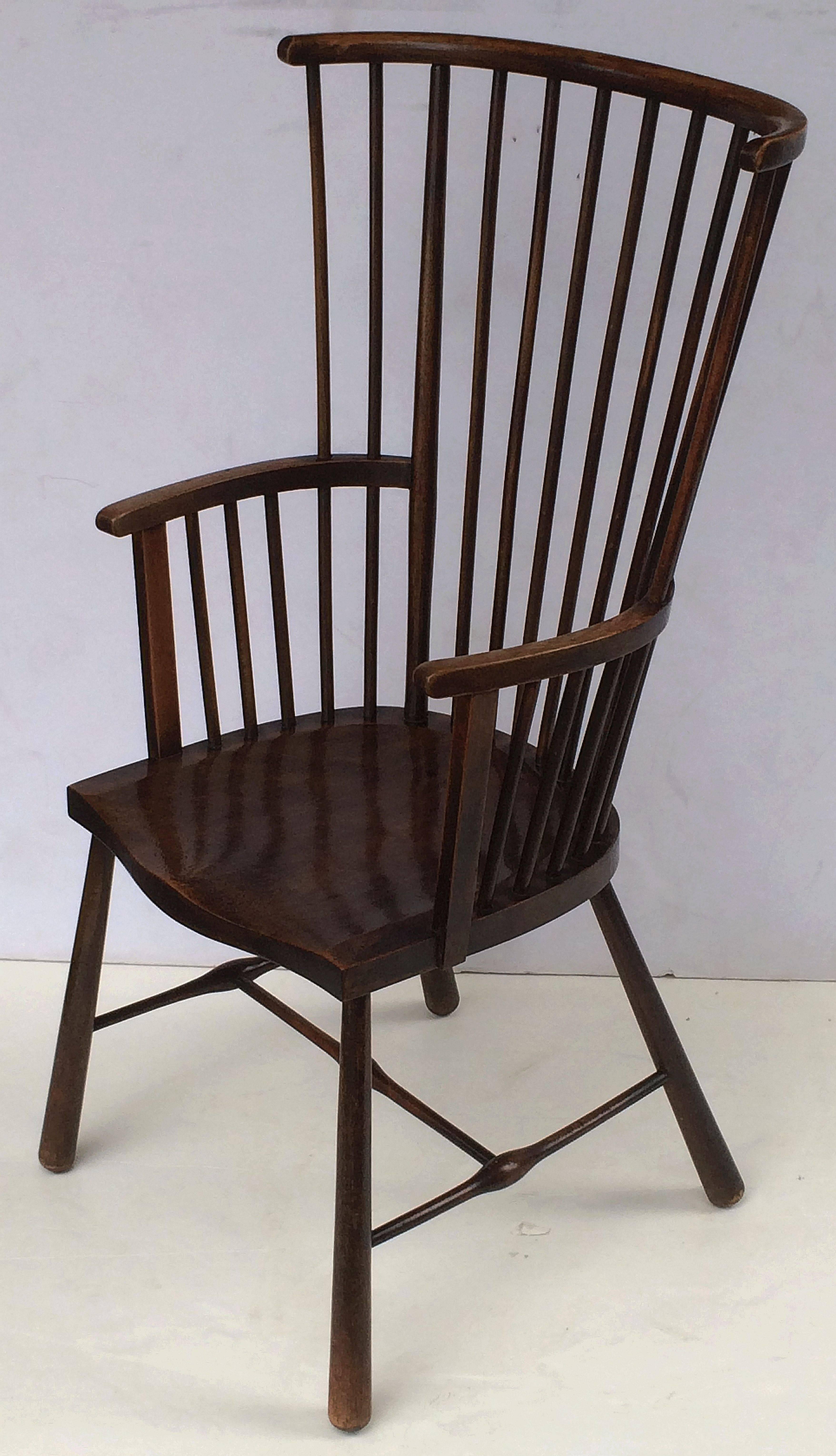 A fine period Windsor armchair (or library chair) from the Arts and Crafts era by the celebrated English design company, Liberty & Co.

With label on underside of seat: Liberty & Co., Regent Street, London