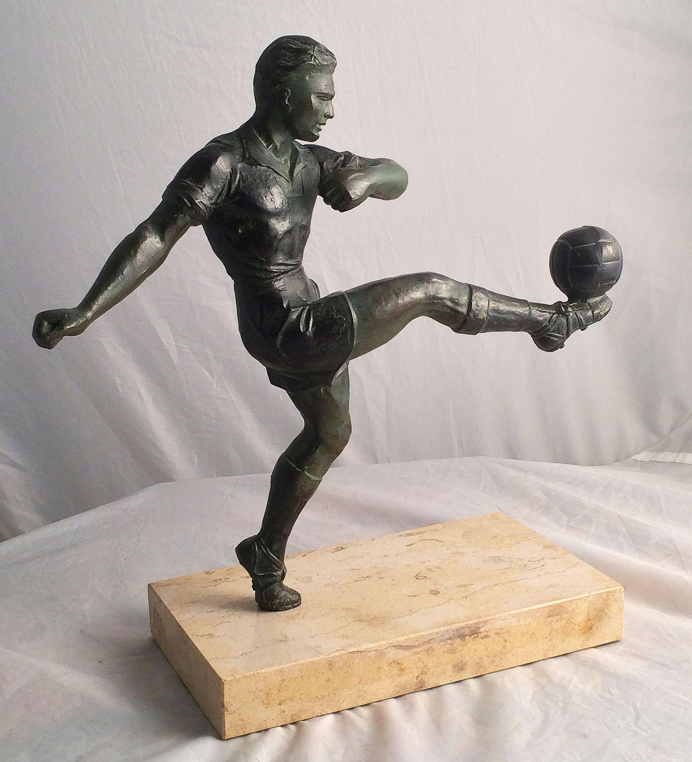 A fine patinated metal sports trophy featuring a figure of a soccer or football player mounted to a rectangular marble plinth base.

Makes a great gift for a soccer player or sports enthusiast.