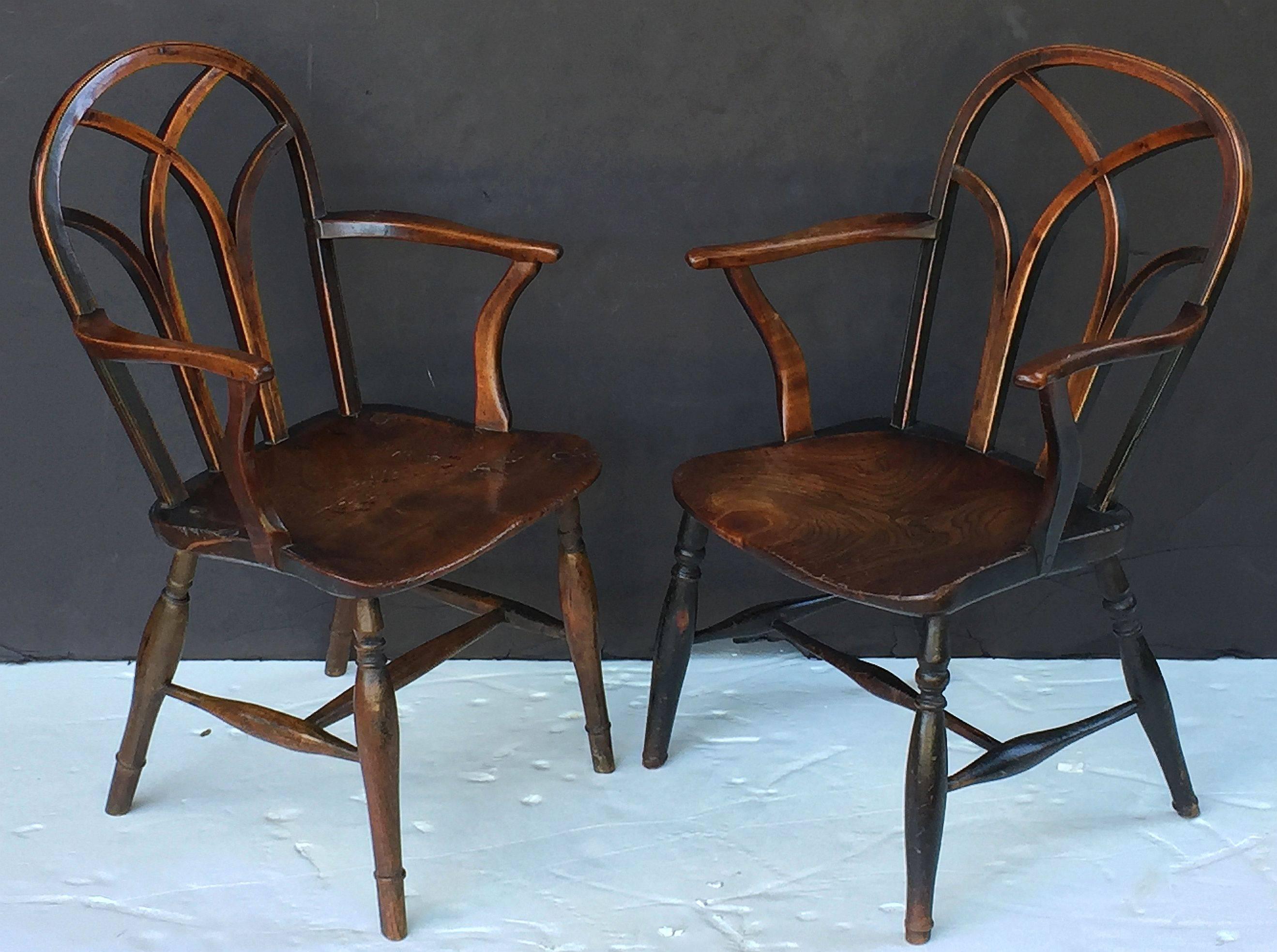 A finely patinated pair of English lowback Windsor armchairs of ash from the Georgian era, circa 1790, featuring interlaced bow backs with nicely turned arms, figured seats and handsomely turned legs. 

Individually priced - $3495 each.