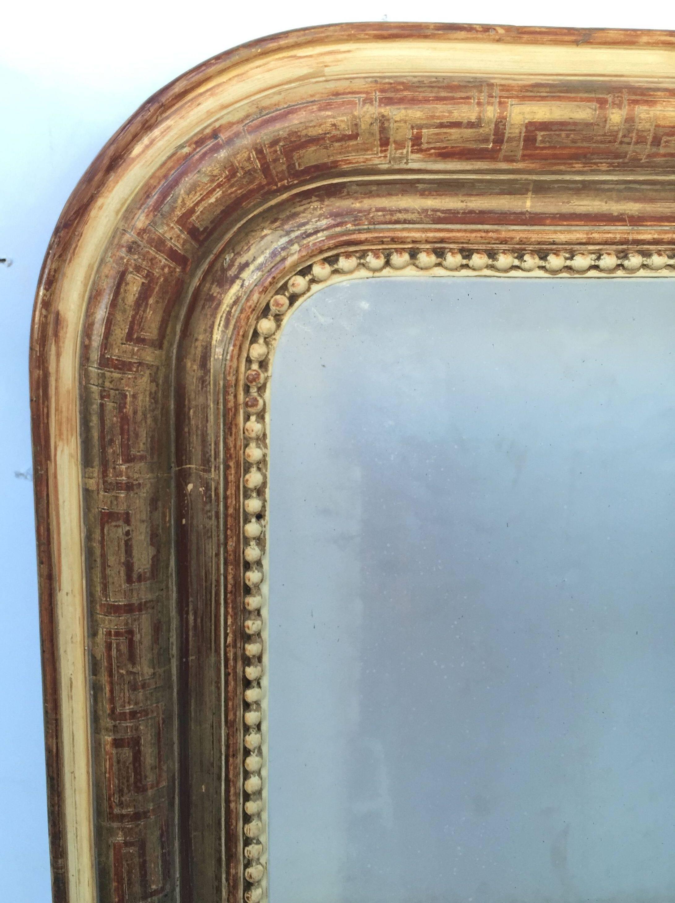 A handsome large Louis Philippe gilt wall mirror from France, featuring a lovely moulded surround and an etched Greek key design showing through gold-leaf.

Dimensions: H 47 1/4 inches x W 35 1/4 inches

Other sizes available in this style.