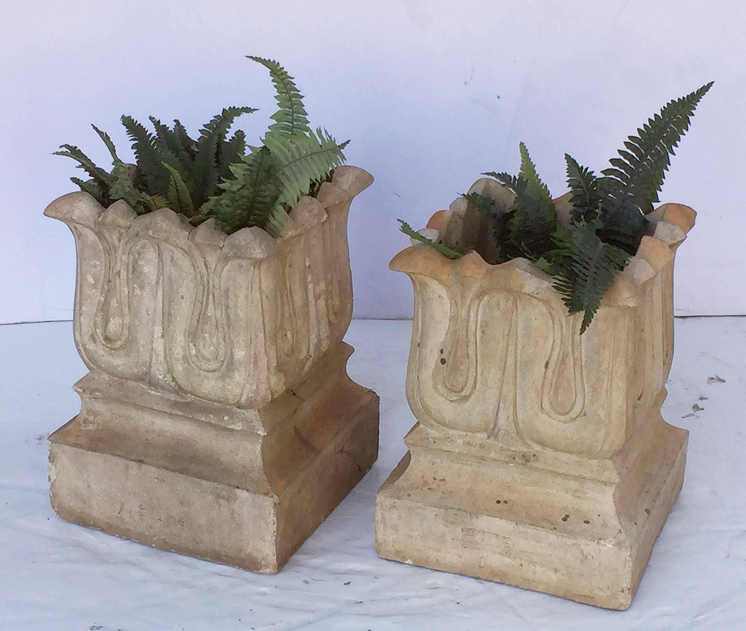 A pair of terra cotta garden planter pots or square urns manufactured by the celebrated ornamental terracotta designer and manufacturer, John Marriott Blashfield. Each vase featuring a Classical stylized lotus design on plinth base.

Priced