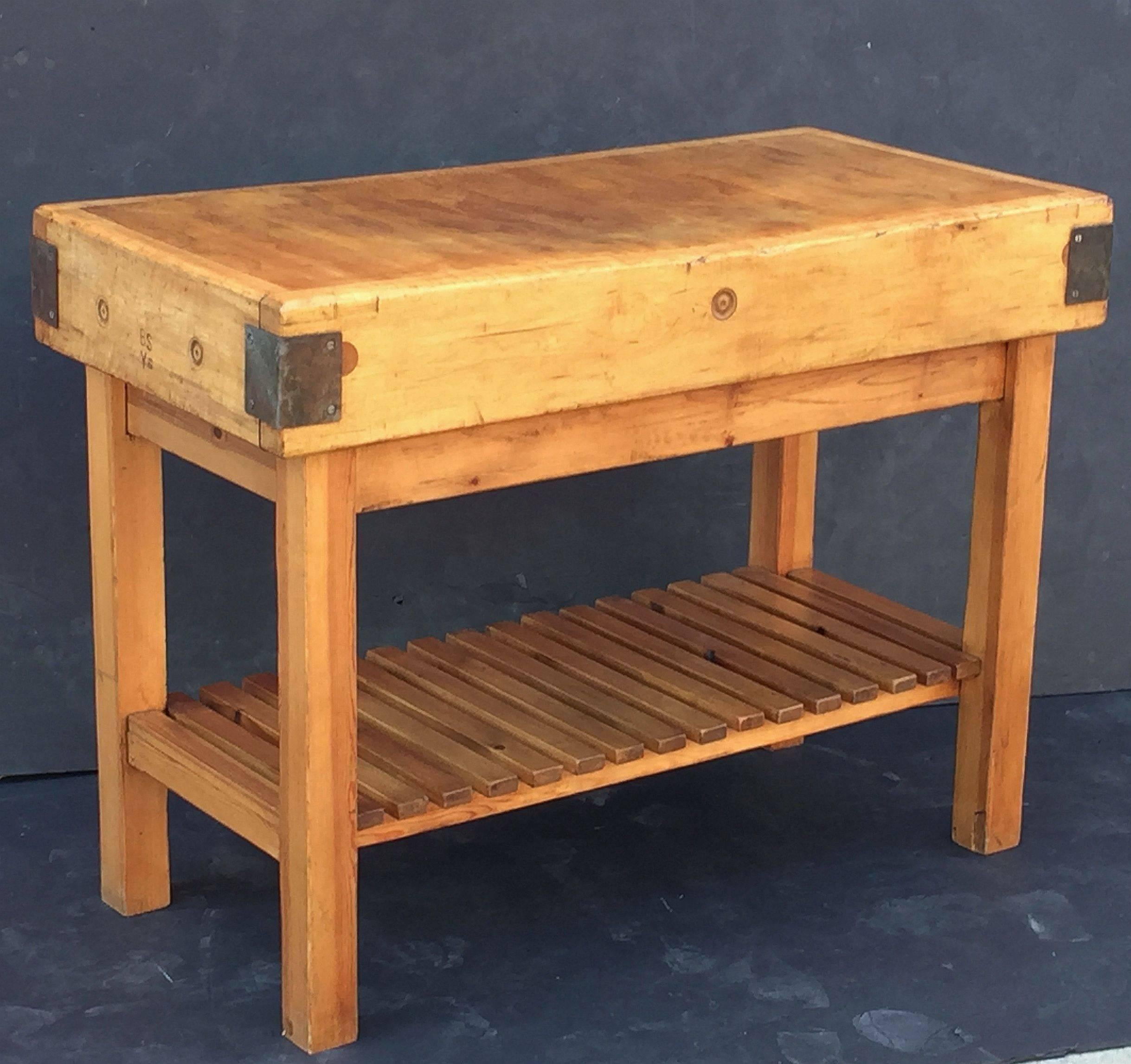 A handsome large French butcher's chopping block table, featuring a large, rectangular block or slab of iron-bound wood set upon a bottom tier four-legged, paneled support Stand of pine. Ships in two pieces.

Makes a great kitchen island or