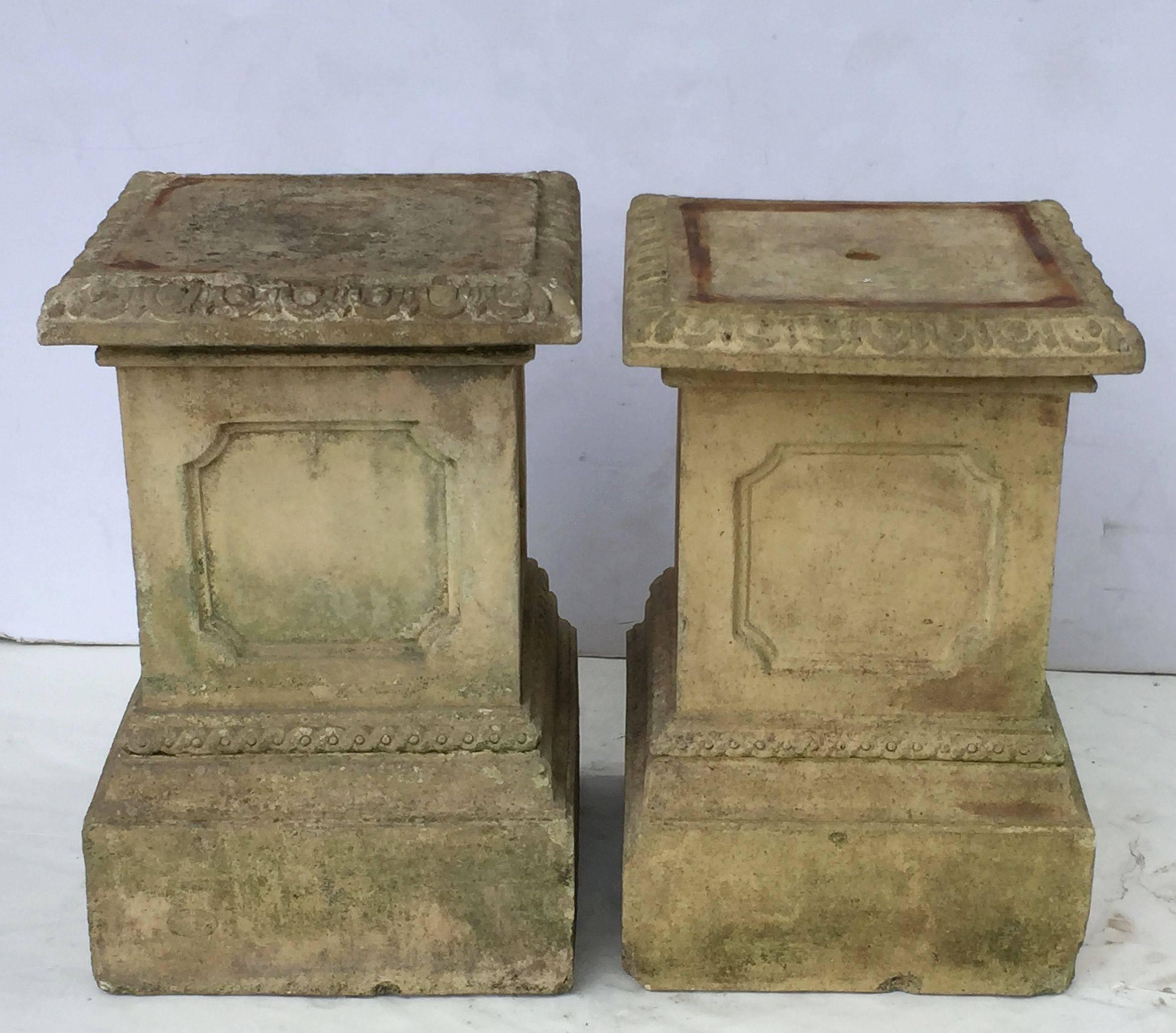 A fine pair of 19th century English garden pedestal plinths of terracotta earthenware, each featuring a design in the Classical style, with egg-and-dart edge on top, four inset panels and raised base.

H 19 1/2
