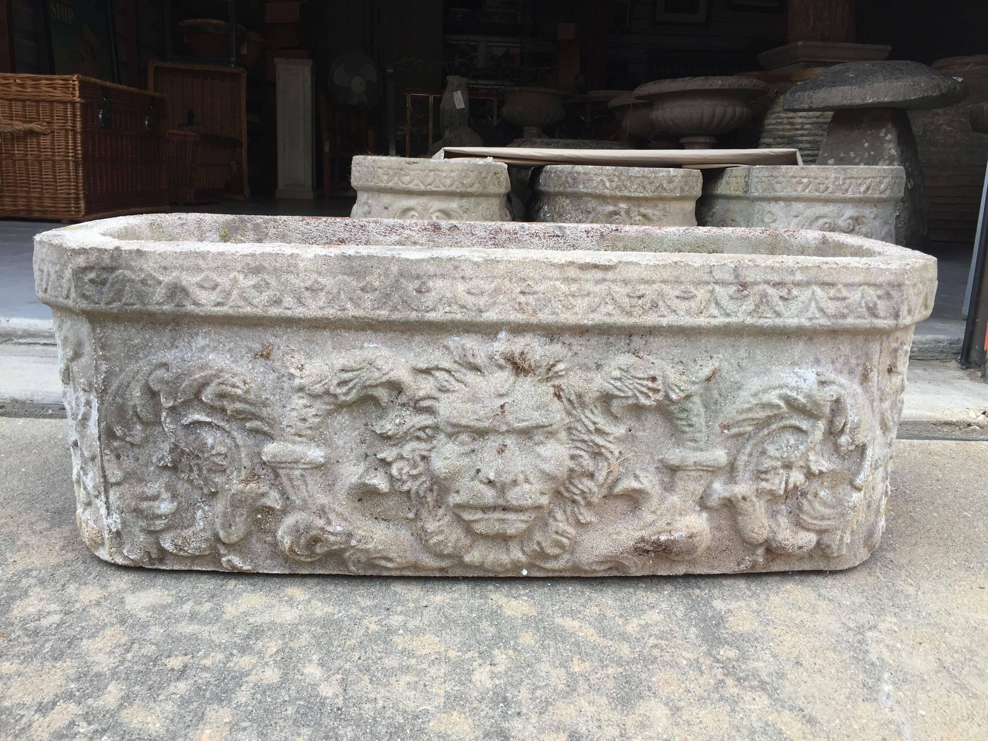 A selection of four large English garden troughs (or planters) of composition stone, each with Fine lion's mask relief detail to each long side and featuring a green man design on the opposing ends.

Dimensions: H 10