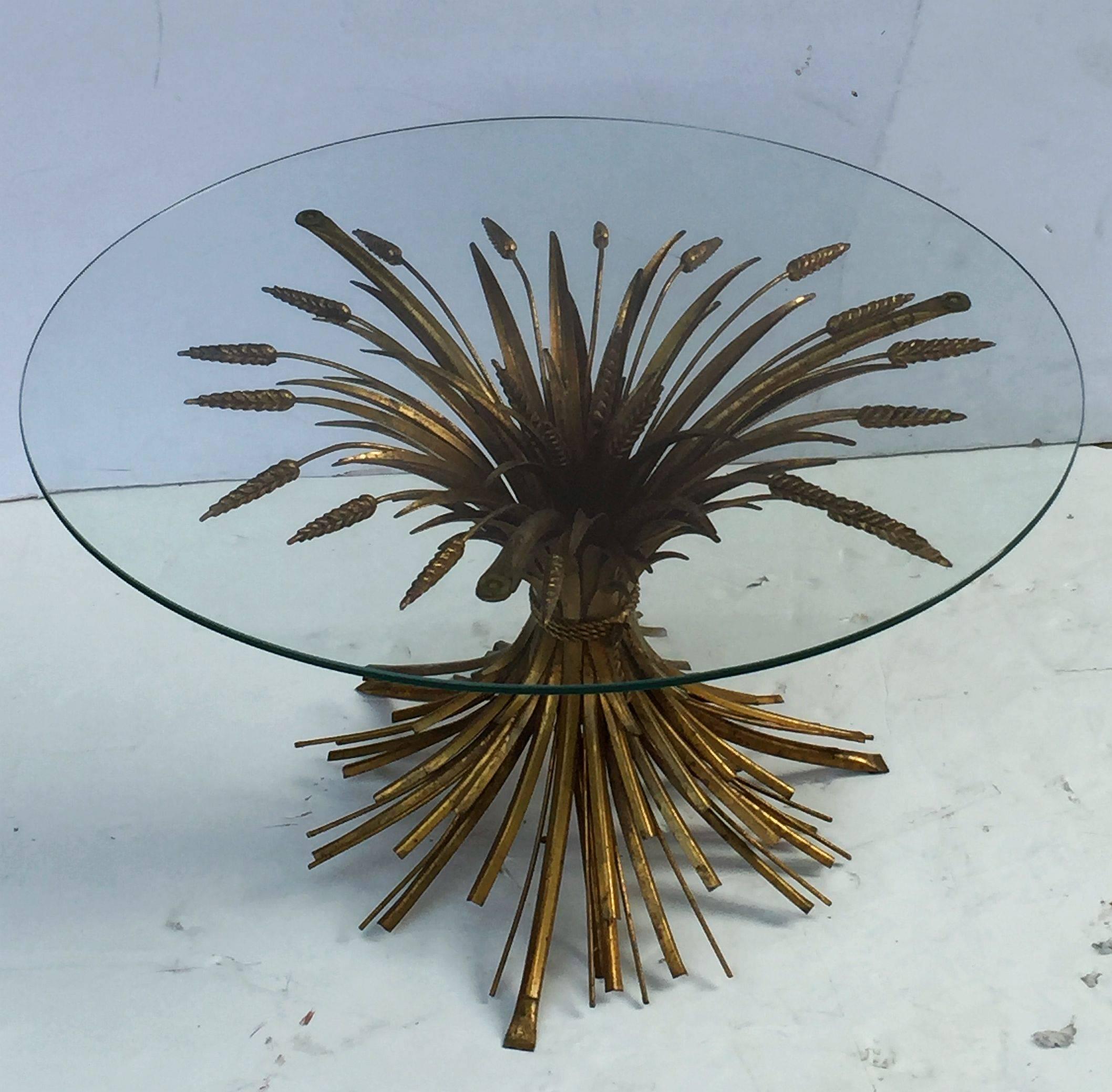 A fine Italian wheat sheaf cocktail or coffee table (or low table), featuring a round glass top set upon a beautifully designed and constructed sheaf of wheat base, with original gilt finish. Perfect for use as an end or side table.

Please enquire