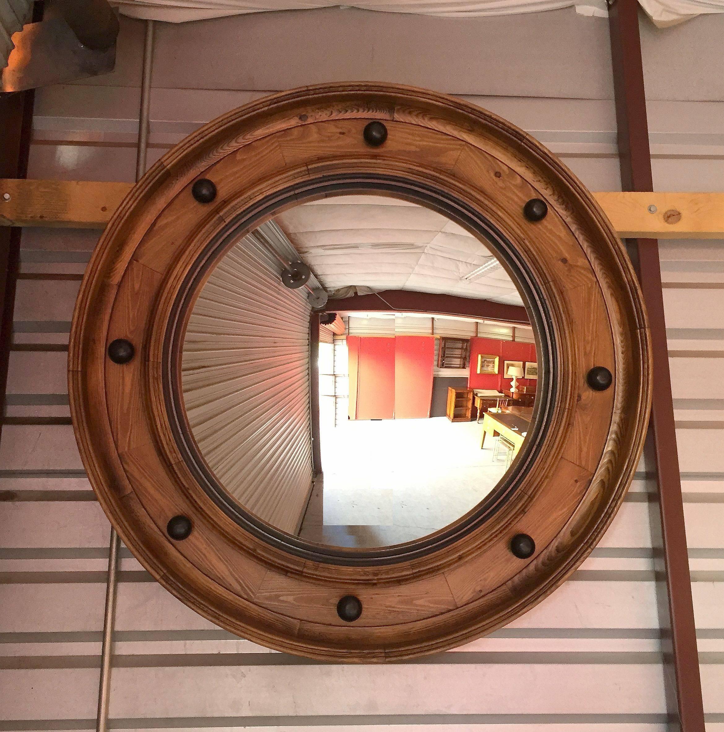 A large English convex mirror (42" diameter) featuring a toned, moulded wood frame with black accents.