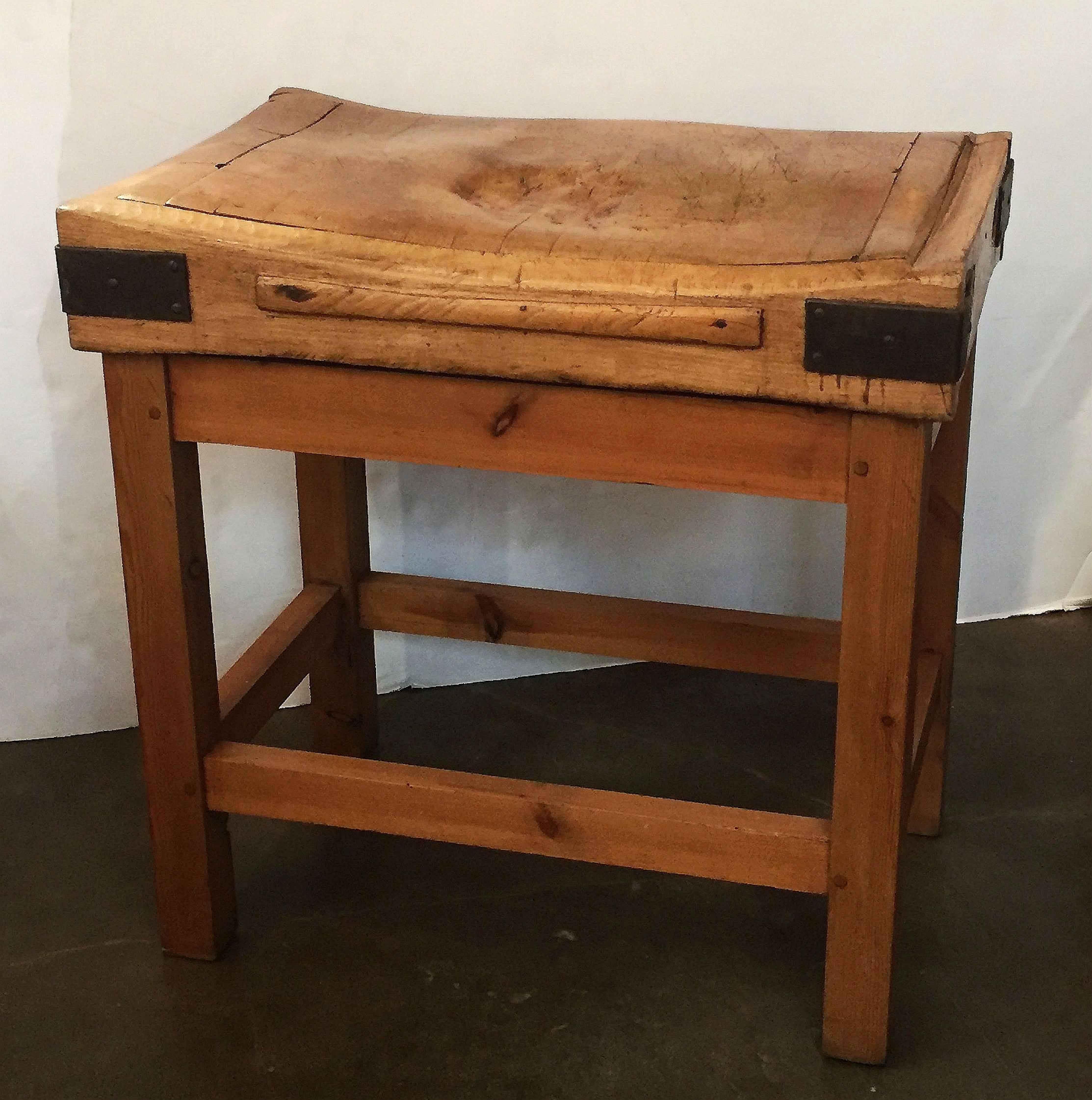 A handsome large French butcher's chopping block table, featuring a large, rectangular block or slab of iron-bound wood set upon a bottom tier four-legged, panelled support stand of pine. Ships in two pieces.

Makes a great kitchen island or