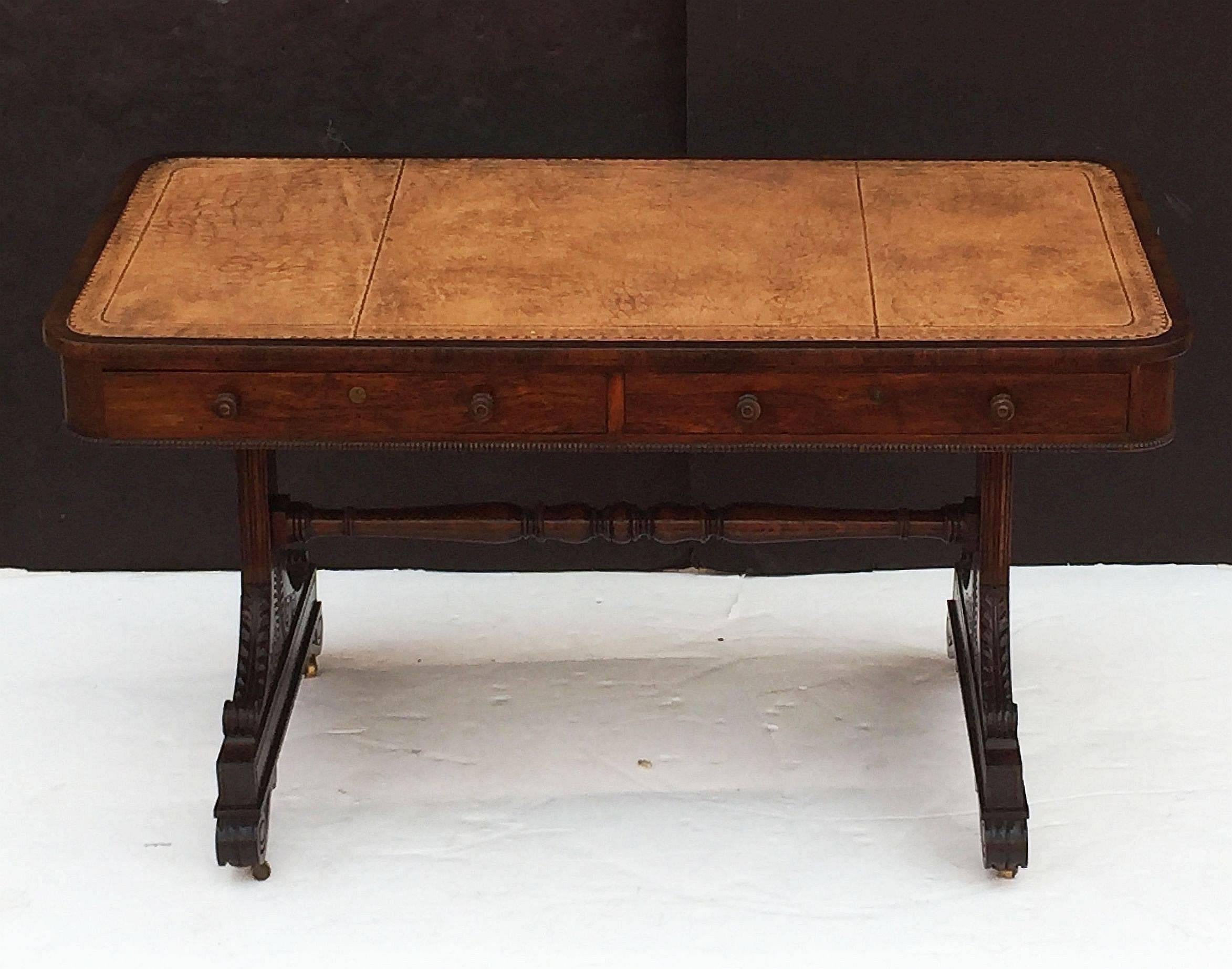 A fine Scottish library table or writing desk with rectangular embossed leather top from the Regency era, in the manner of Trotter of Edinburgh, over a frieze of two facing long drawers and faux drawer fronts on the opposing side and each end,