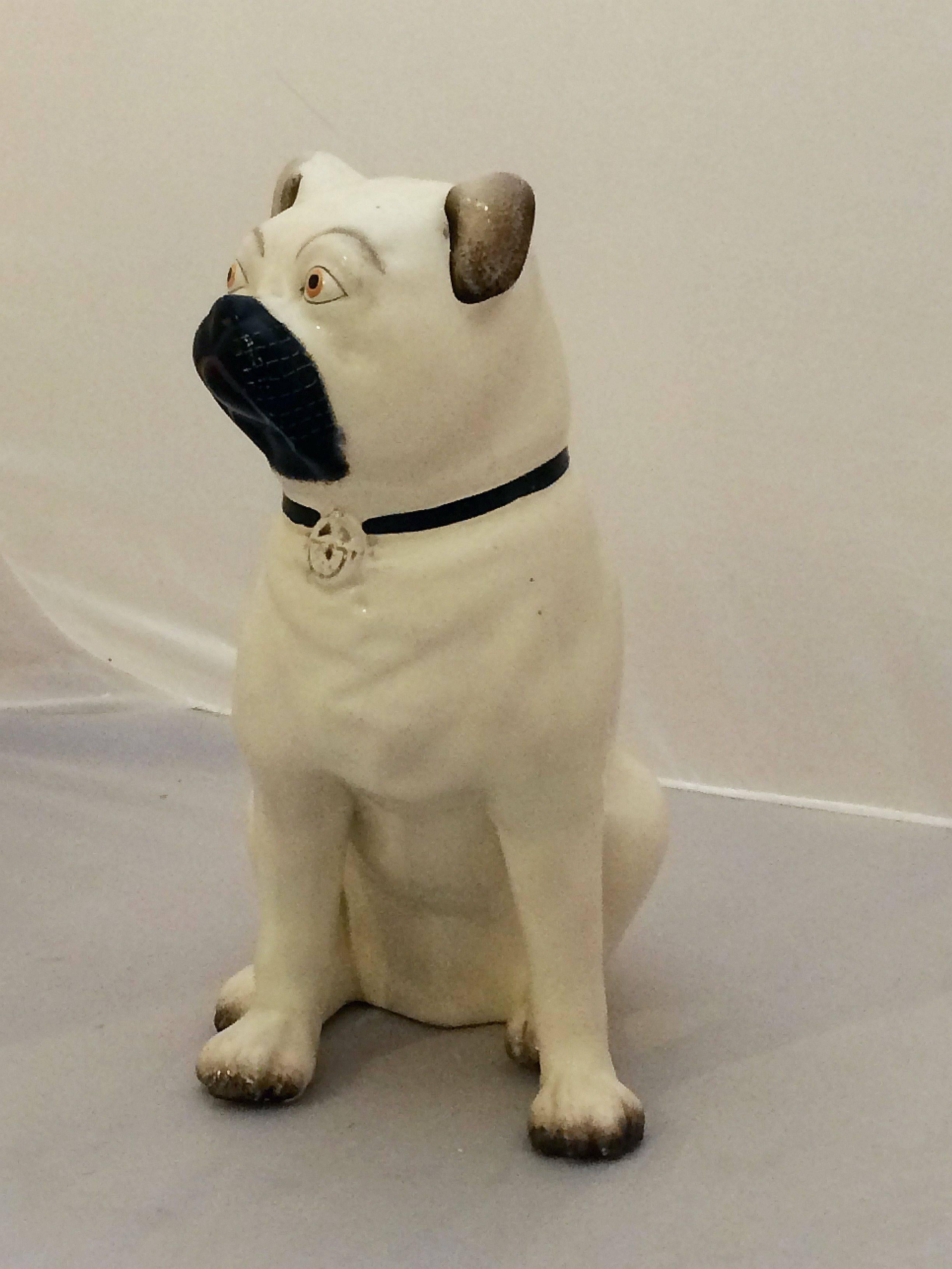A fine model of an English pug dog from the 19th century Staffordshire Potteries in England, featuring separated legs and fine modeling in the round.