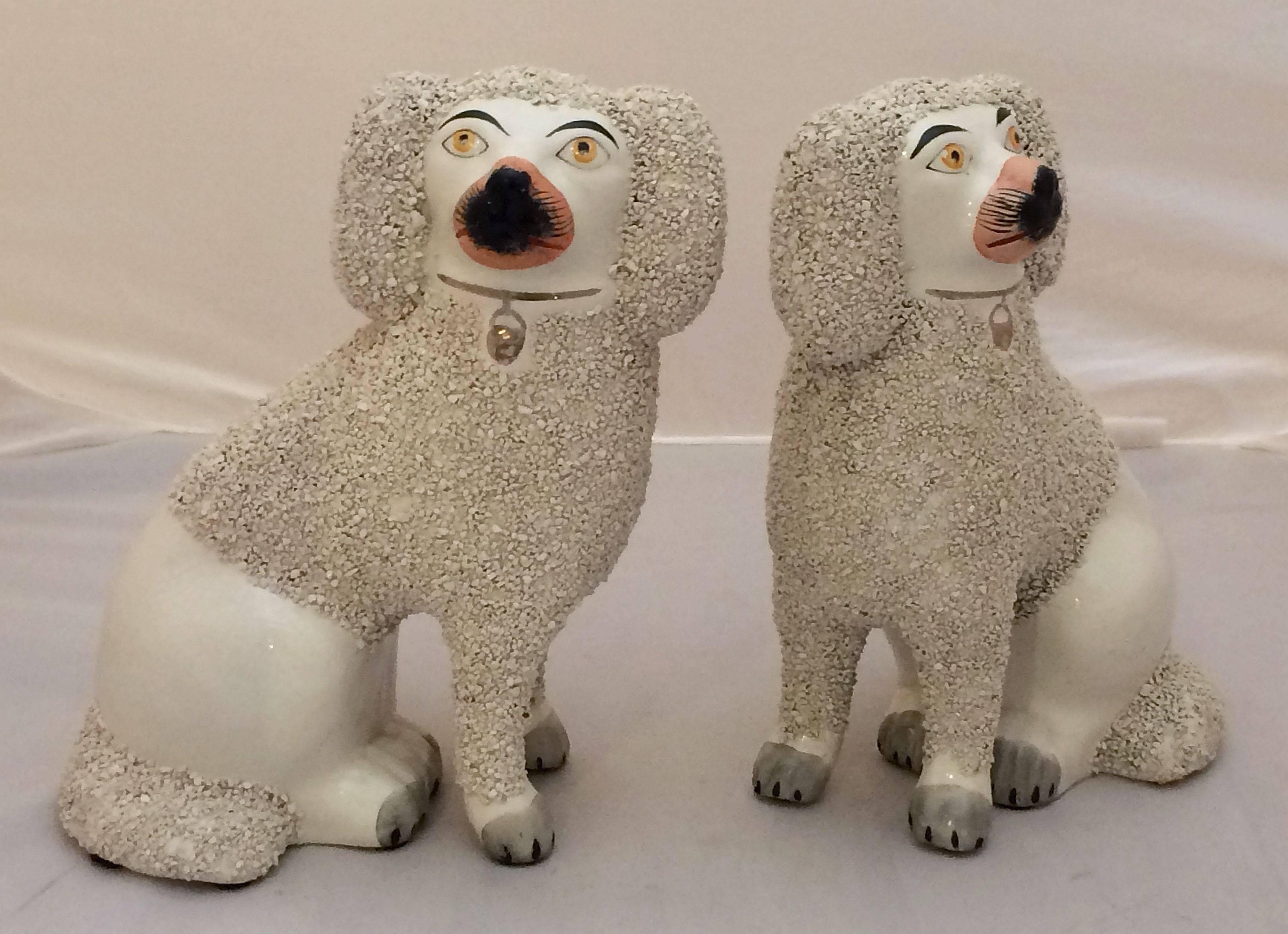 A fine pair of large poodle dogs from the 19th century Staffordshire potteries in England, each poodle featuring separate leg modeling and fine detail painting in the round.

Priced as a pair - $895 the pair.