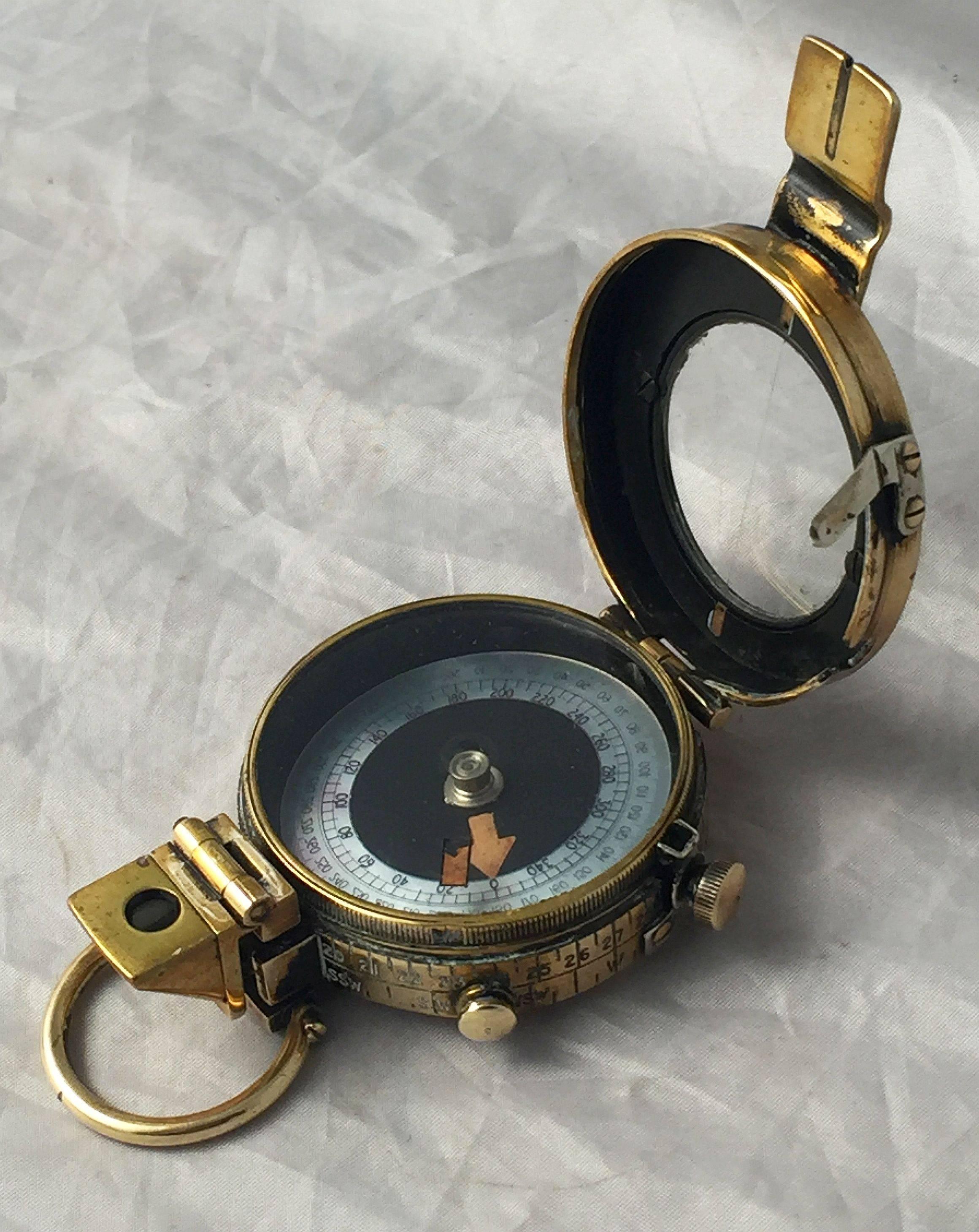 A working British military officer's marching or sighting compass of heavy brass in original leather case from World War I.

Known as a Verner's pattern Mark IX prismatic compass, with radium and mother-of-pearl dial.

Leather case with arrow
