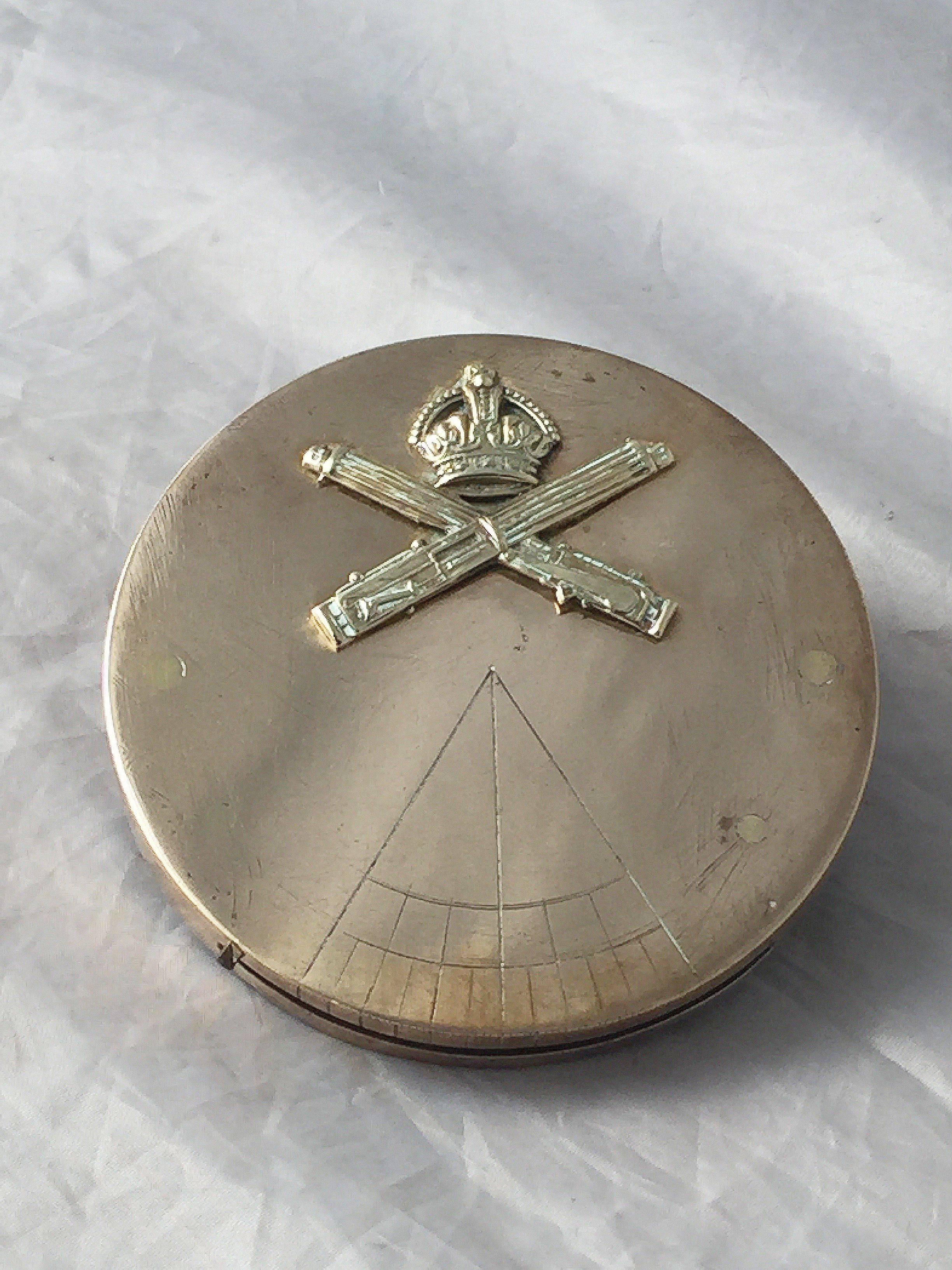 A British military gun level of brass with Machine Gun Corps brass collar badge from WWI.