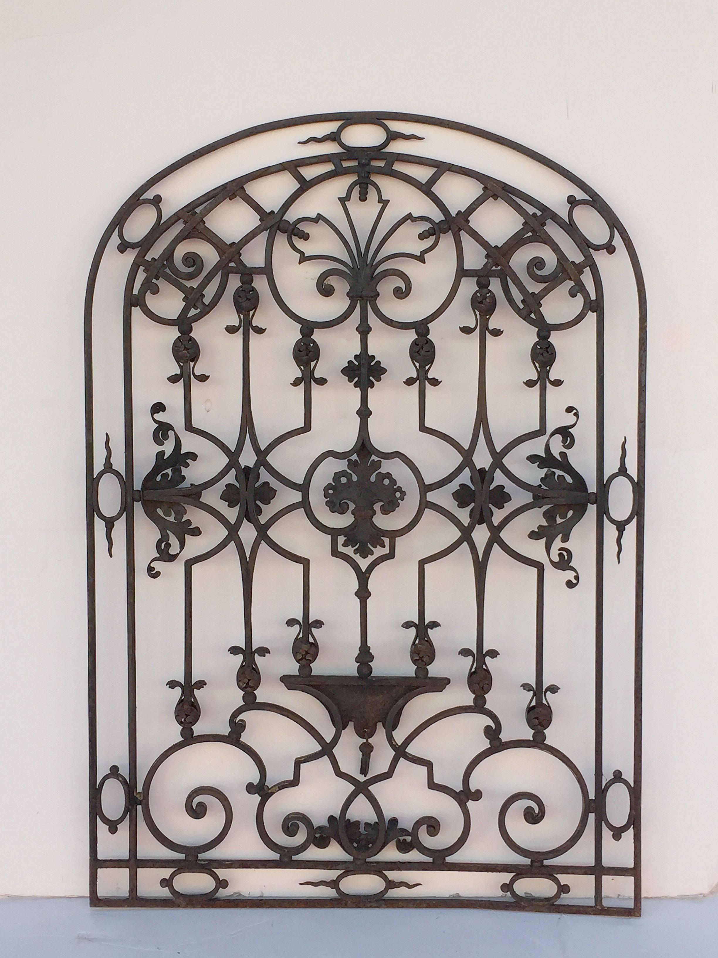 A handsome large French arched gate of wrought iron from the 19th century, featuring a fine design of scroll work and decorative embellishments.

Perfect for a garden room or conservatory or for use as a trellis or architectural feature.