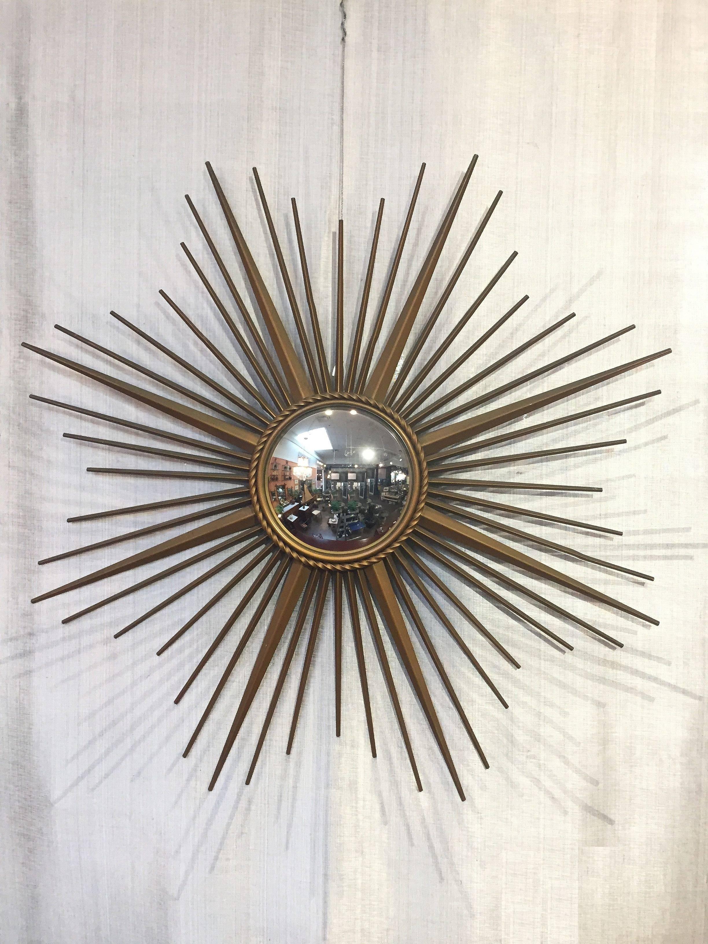 A fine French gilt metal sunburst (or starburst) mirror, 33.5 inches diameter, with convex mirrored glass center in moulded frame with rope motif trim by Chaty Vallauris.

With impressed mark of maker on back.

The Chaty Vallauris starburst or