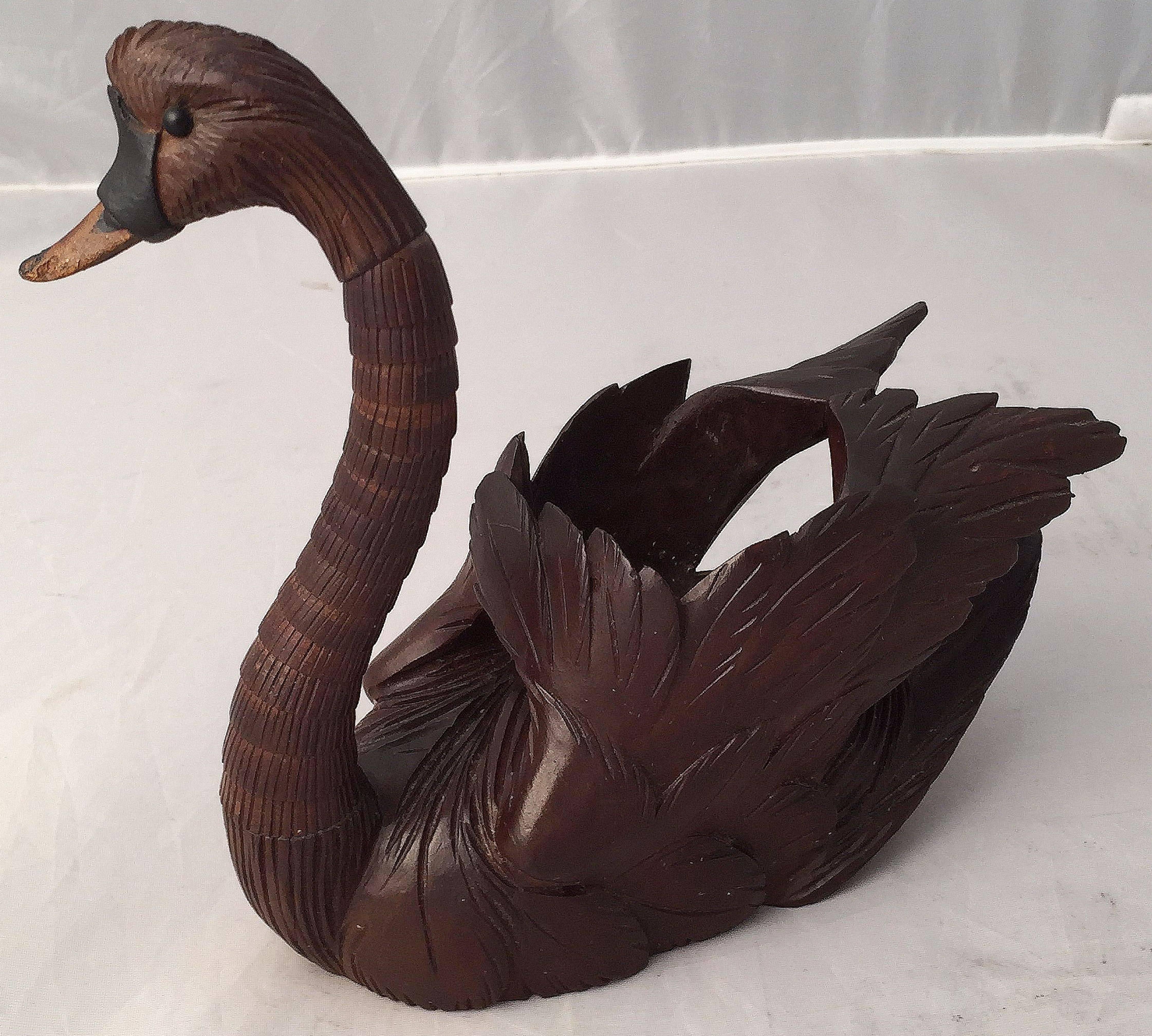 A fine Black Forest swan figure of carved linden wood from Switzerland, featuring an articulated neck, allowing the head to swivel in 360 degrees, so to create a variety of poses.
