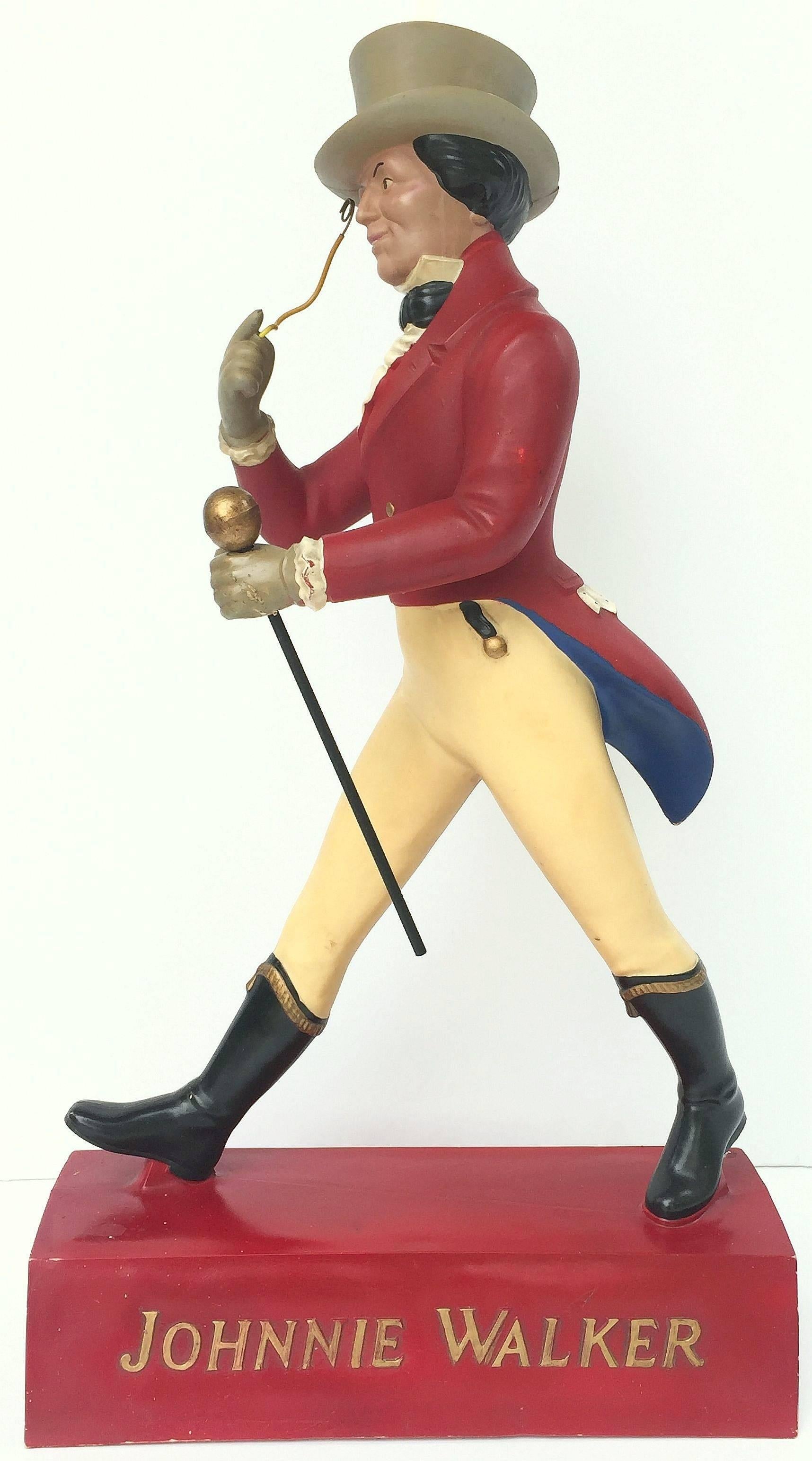 A large vintage advertising prop from Scotland featuring the striding man figurehead or mascot symbol for Johnnie Walker, the celebrated blended scotch whiskey.

The striding man logo, a figure used in their advertisements to this day, was created