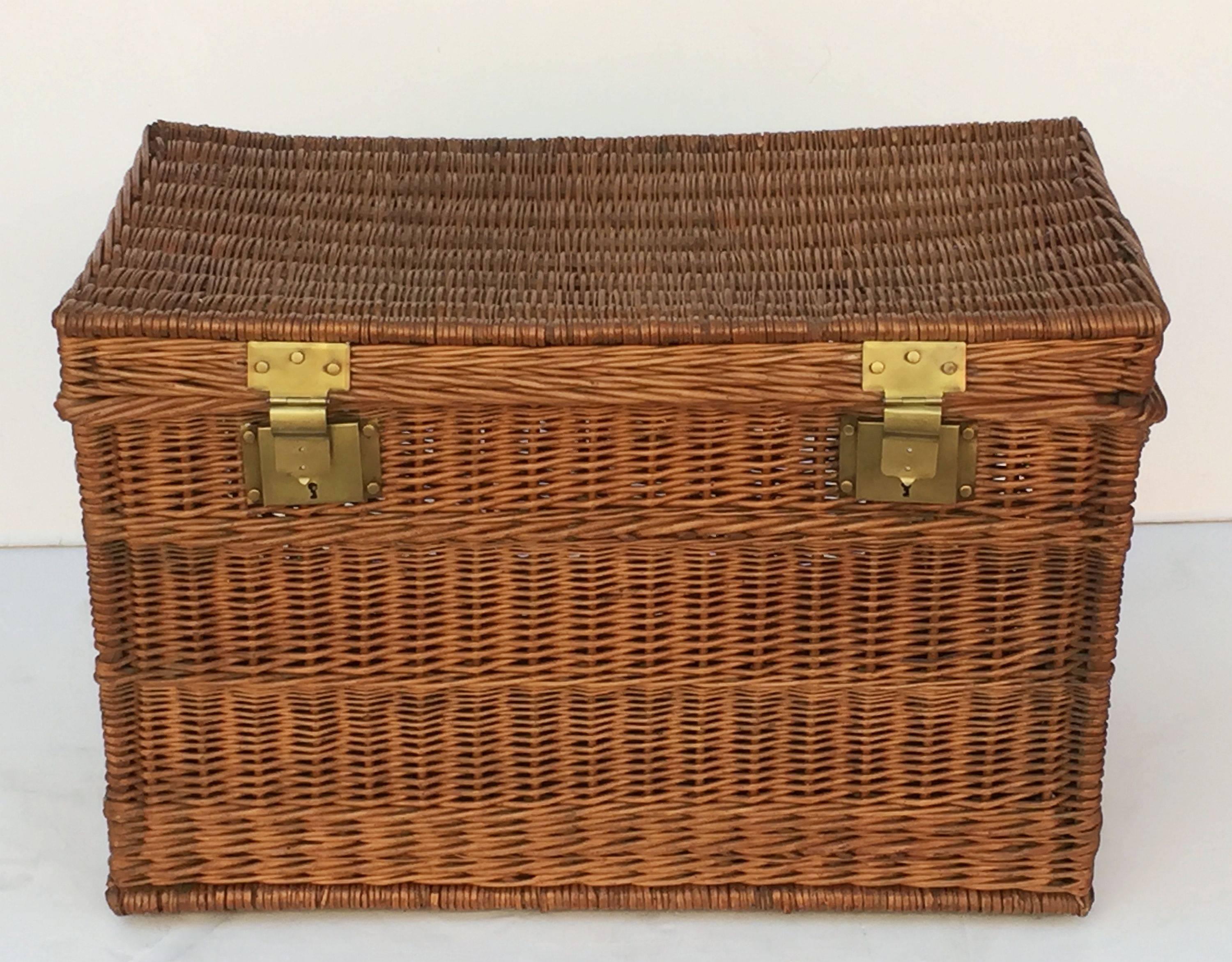 A large French basket hamper of woven willow with brass hardware and handles on each side. With wooden runners on underside.

Several available in this style, slight variations of size, please enquire.

Note: Latches do not always close and