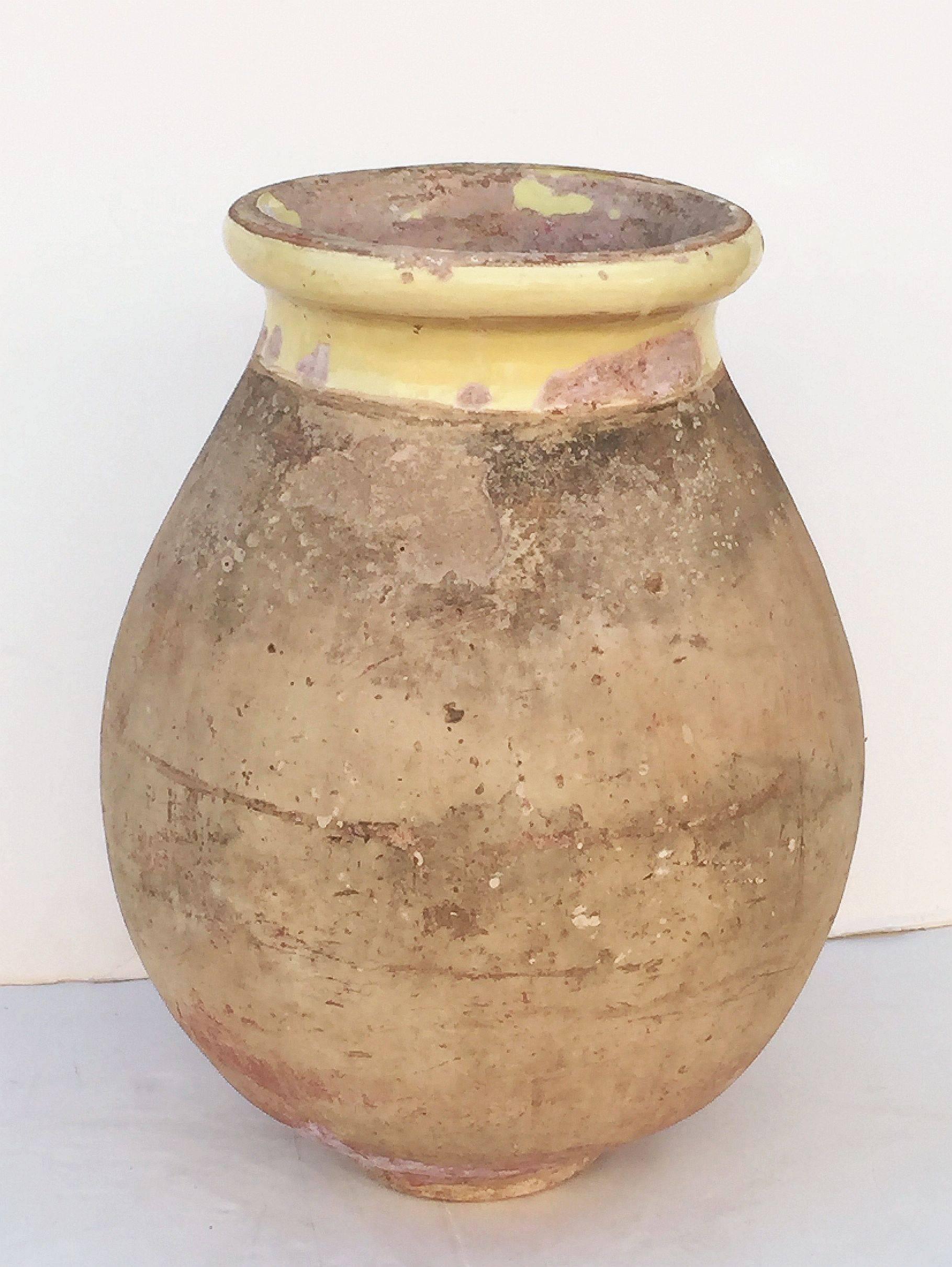 A handsome French garden pot or oil jar from the Biot, Alpes-Maritimes, region known as a pottery centre from the 18th century onward.

Featuring a glazed rolled-edge top over a smooth, cylindrical body and functional as a garden ornament, fountain,