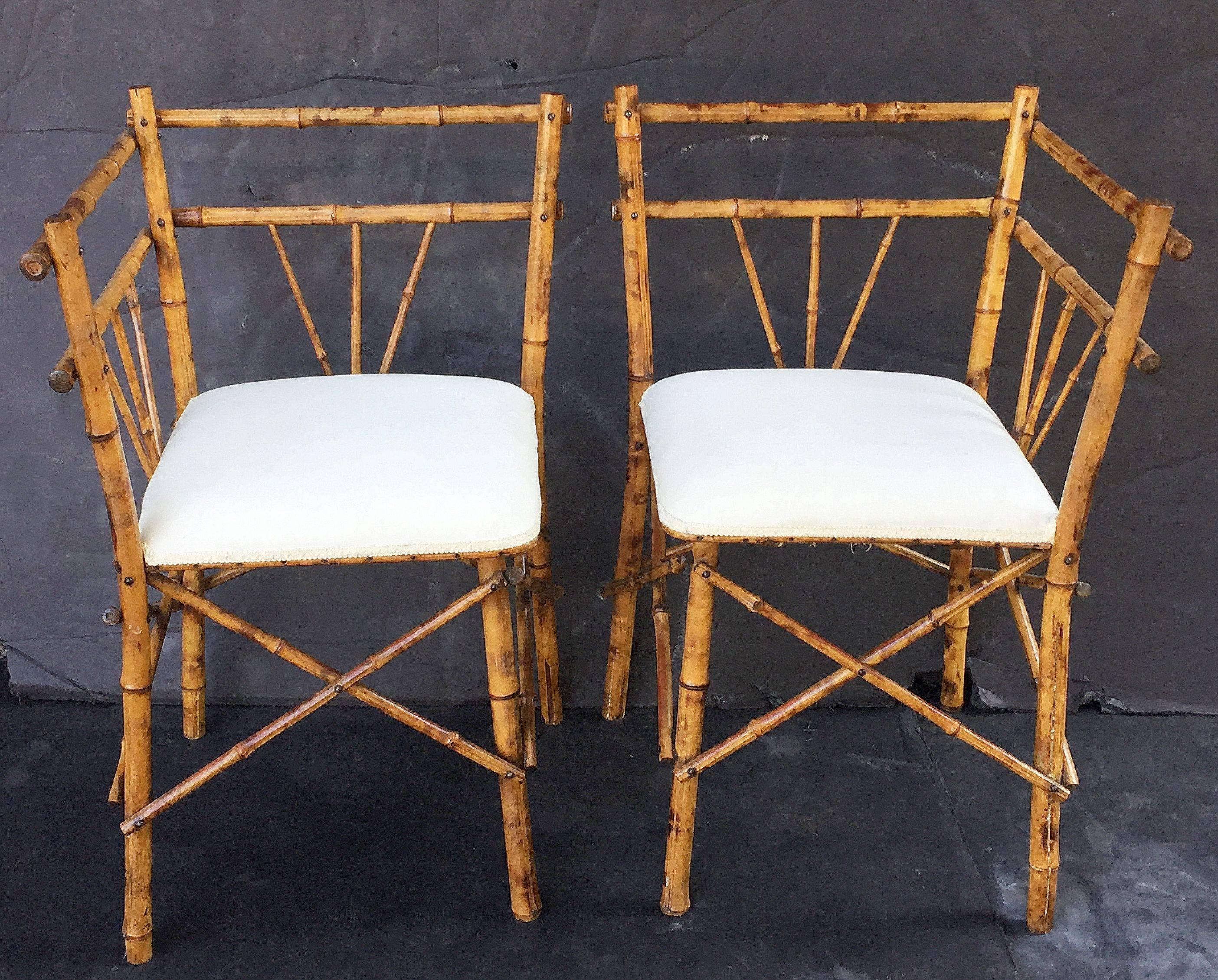 A fine pair of English bamboo upholstered corner or side chairs, each chair featuring a lacquered bamboo back and leg supports, with a comfortable upholstered square seat.

Individually priced- $1295 each chair.