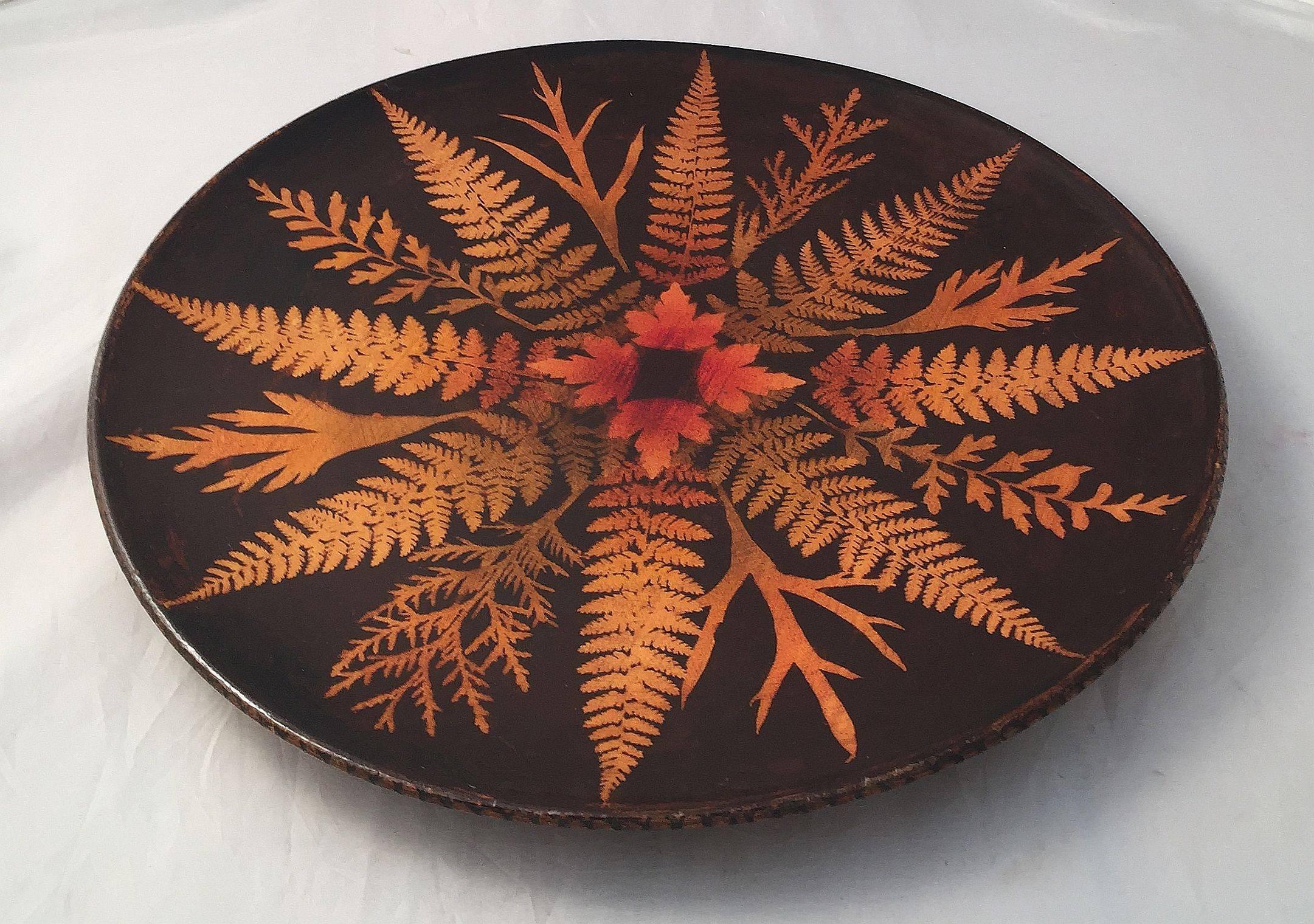 A fine large Scottish fernware charger of varnished sycamore wood and featuring a lovely radiating fern design from the center on the obverse and reverse sides.

Fernware was introduced in the 1870s. This involved applying actual ferns to the wood