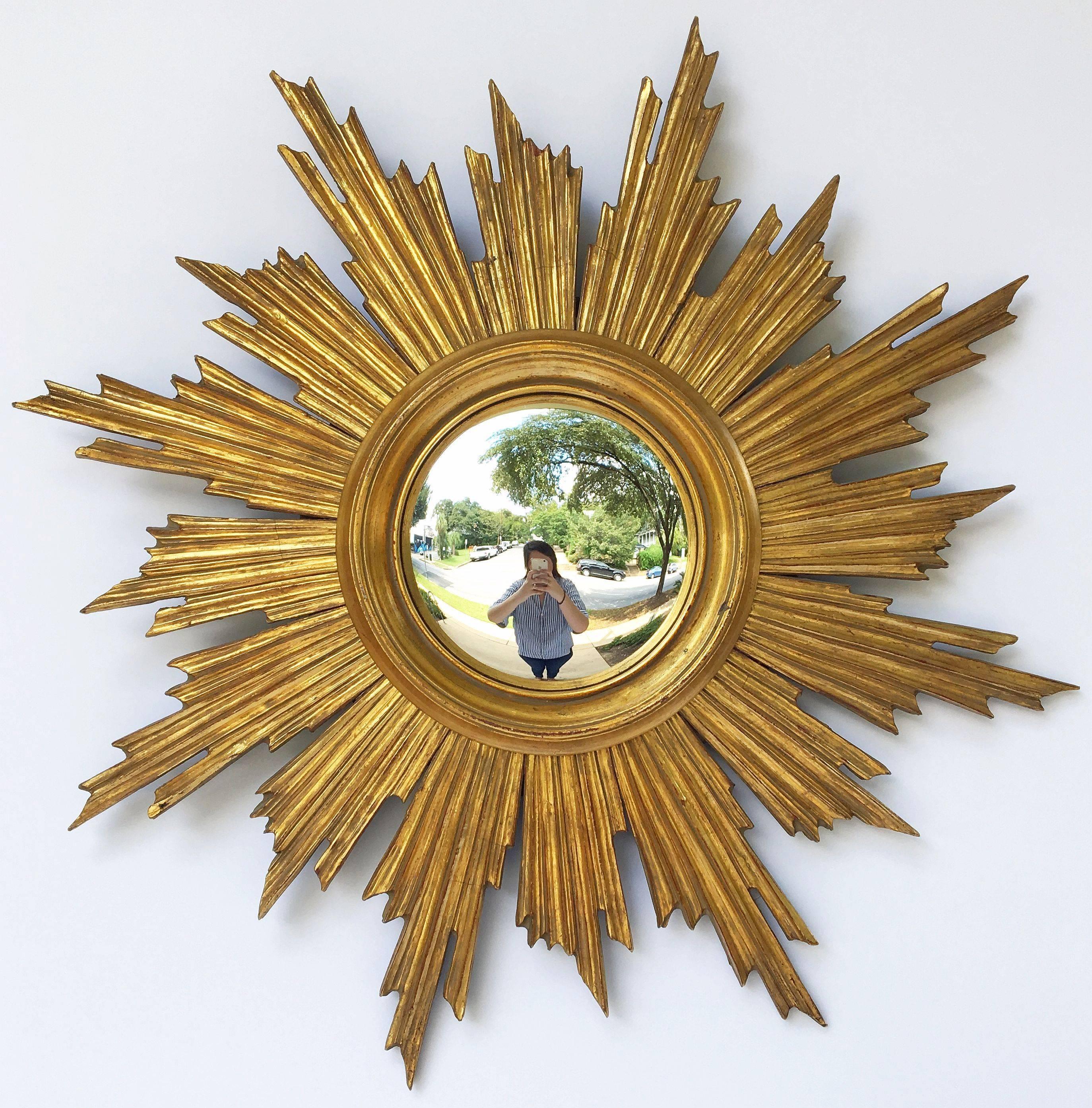 A lovely French gilt sunburst (or starburst) mirror, 25 inches diameter, with convex mirrored glass centre in moulded frame.