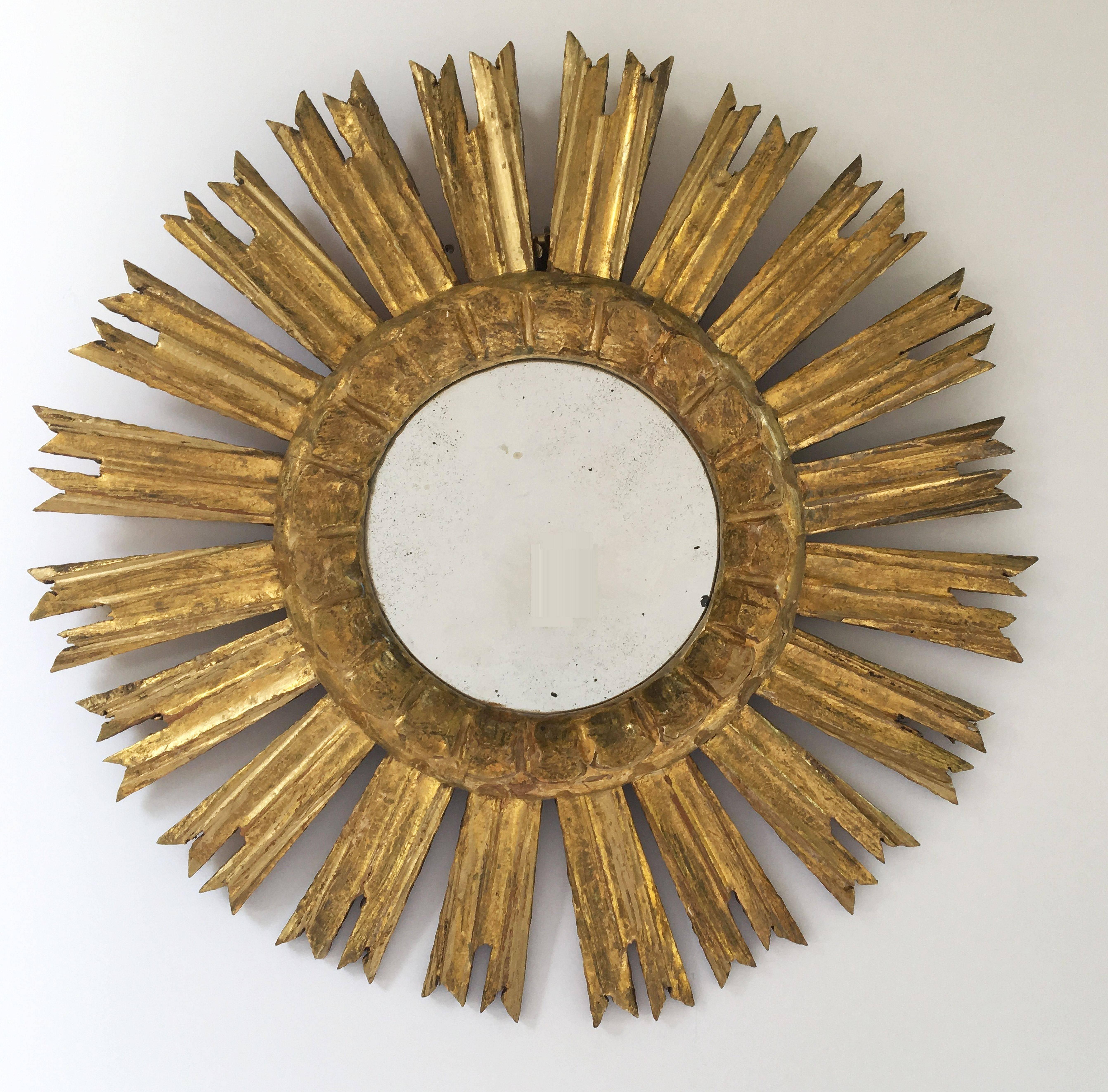 A lovely French gilt sunburst (or starburst) mirror, 16 1/2 inches diameter, with mirrored glass center in moulded frame.

