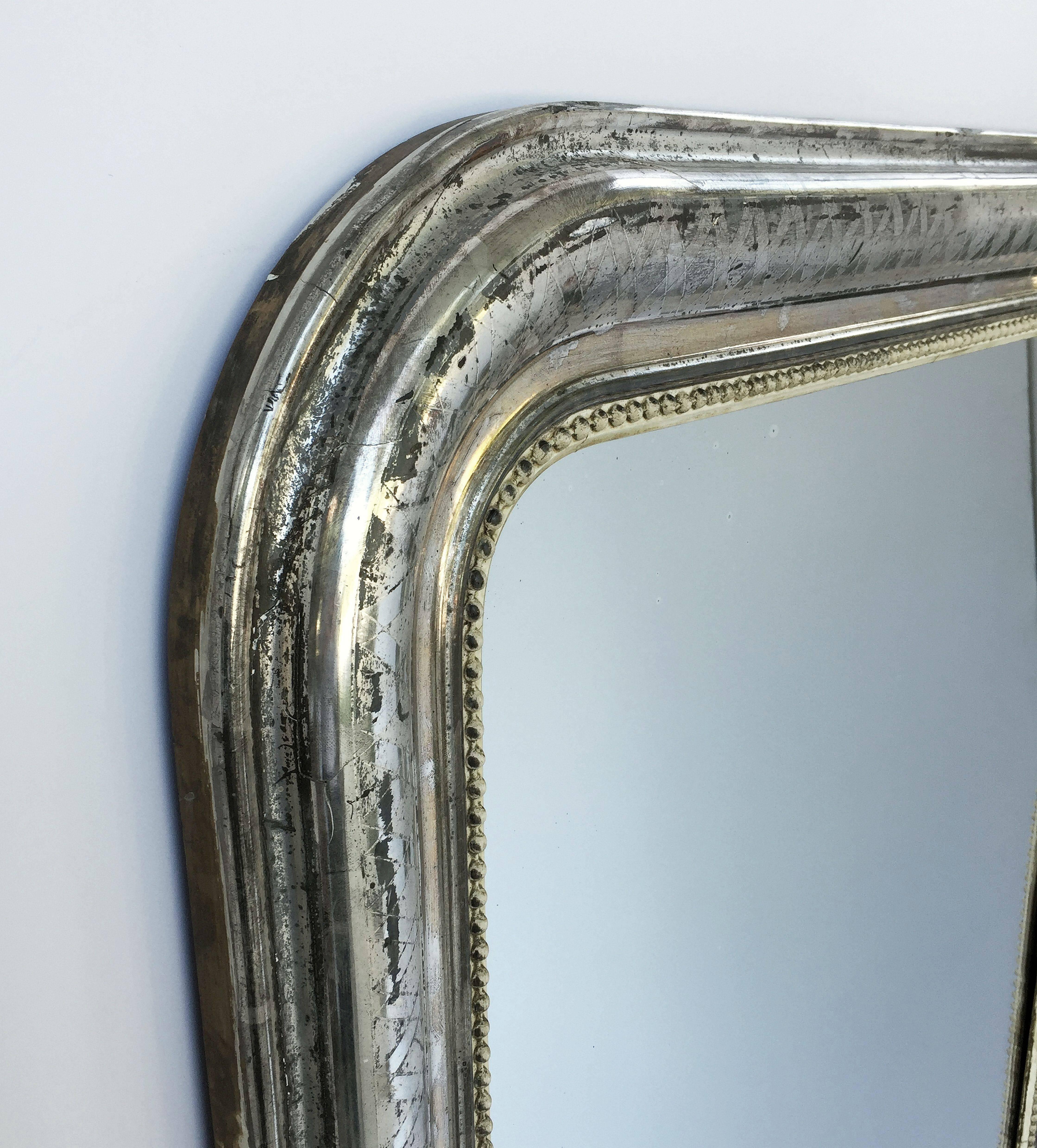 A fine Louis Philippe wall mirror from France, featuring a moulded surround with a beautiful patinated silver-leaf.

Dimensions: H 55 inches x W 34 inches

Other sizes available in this style.