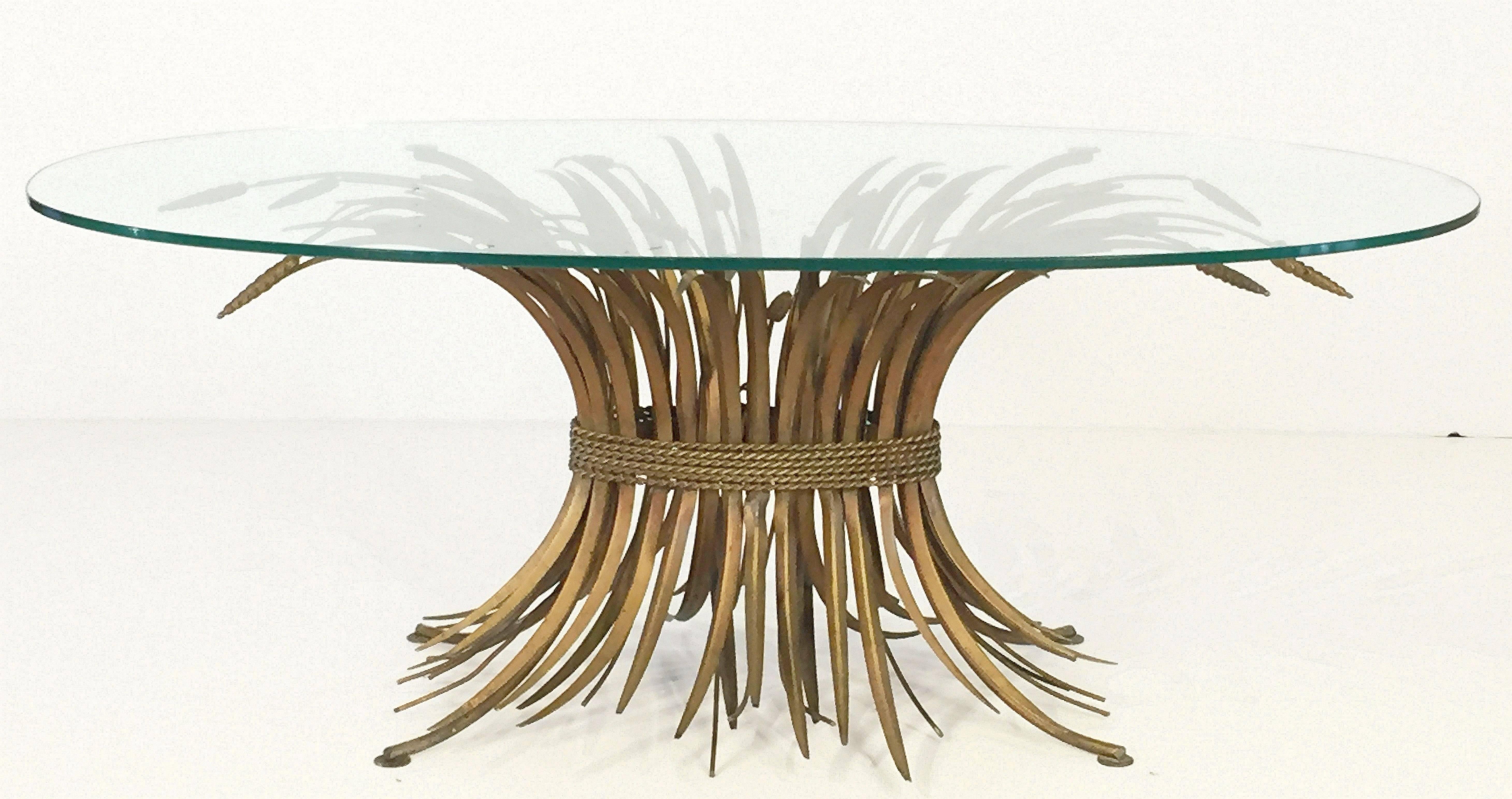 A fine Italian wheat sheaf cocktail or coffee table (or low table), featuring a large oval glass top set upon a beautifully designed and constructed sheaf of wheat base, with original gilt finish. Perfect for use as an end or side table.




 