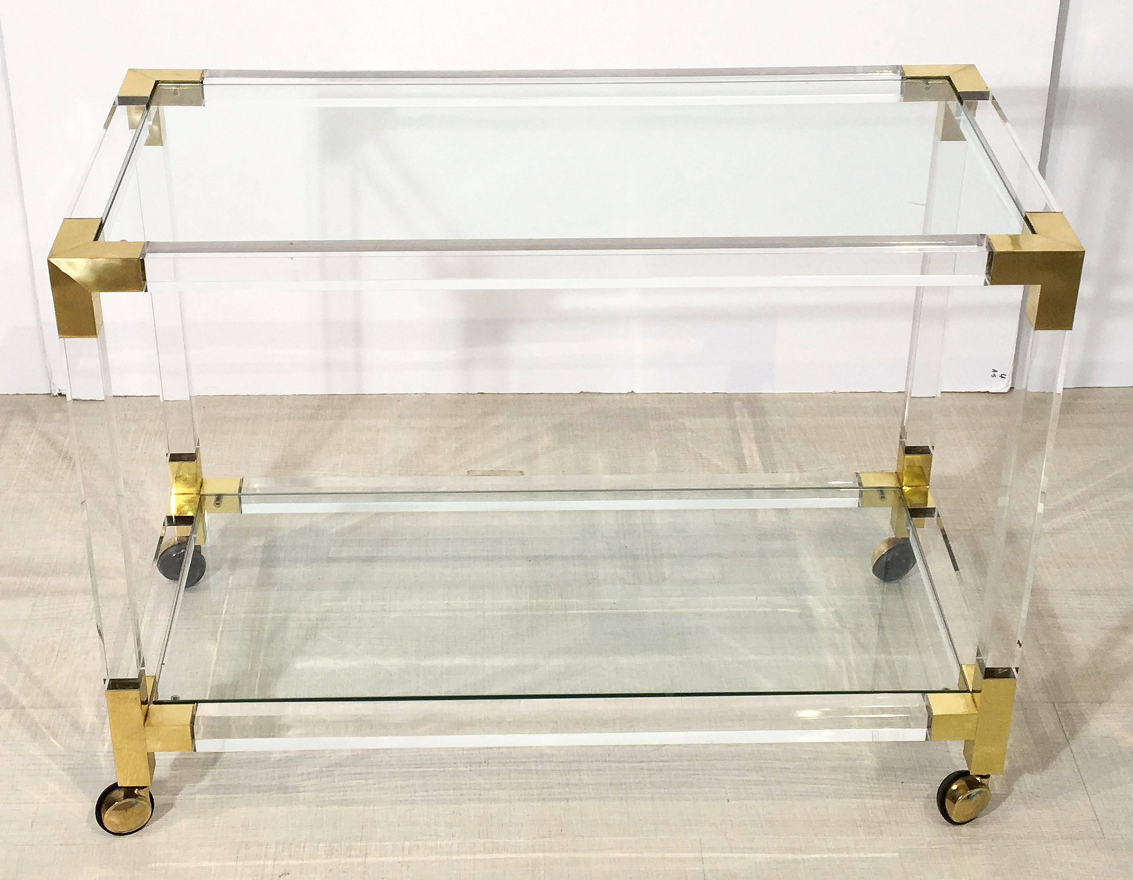 A fine French drinks trolley or bar cart, featuring two tiers of fitted rectangular glass in a clear Lucite frame with brass accents, on rolling casters.

Makes a great side or occasional table.